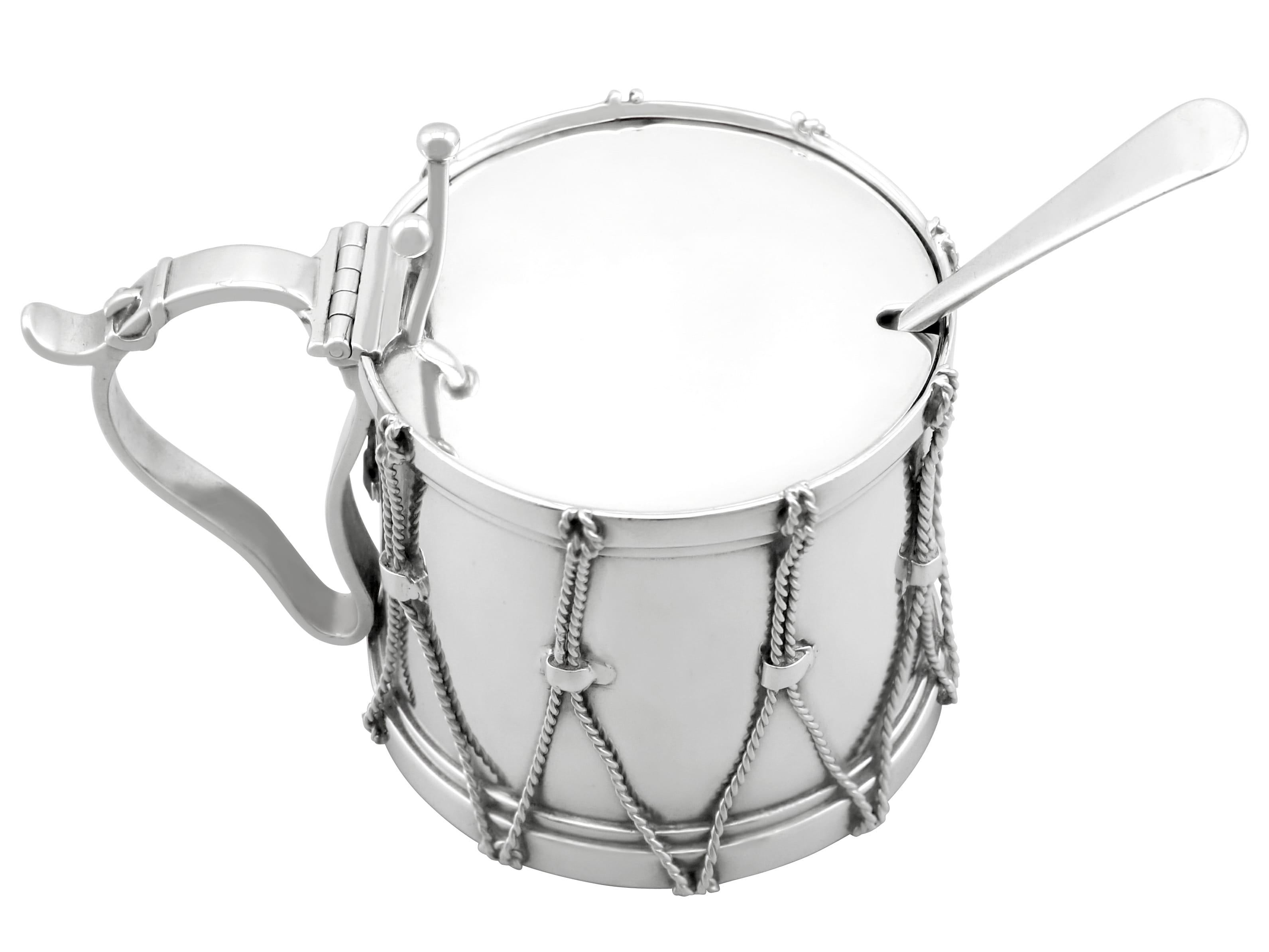 This exceptional and rare antique Victorian sterling silver mustard pot has been realistically modelled in the form of a drum.

The cylindrical body is embellished with cast and applied rope twist decoration accented with impressive belt strap
