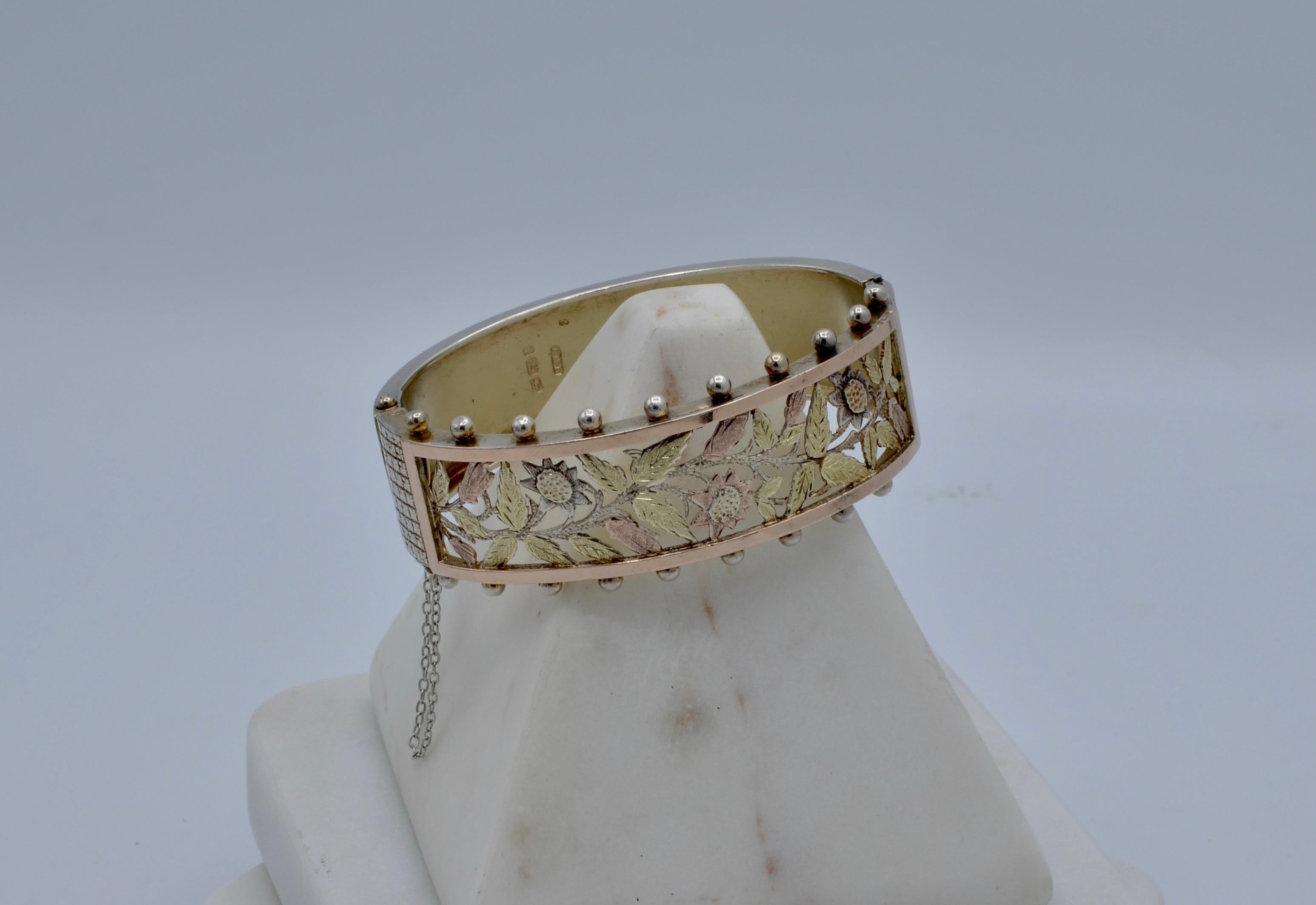 This handmade English Cuff is a beautiful example of  Victorian Floral Motif Jewelry. The 14 karat yellow and rose gold engraved leaf pattern is ornately detailed with Sterling silver beads on the outside edge. During the Victorian Era silver