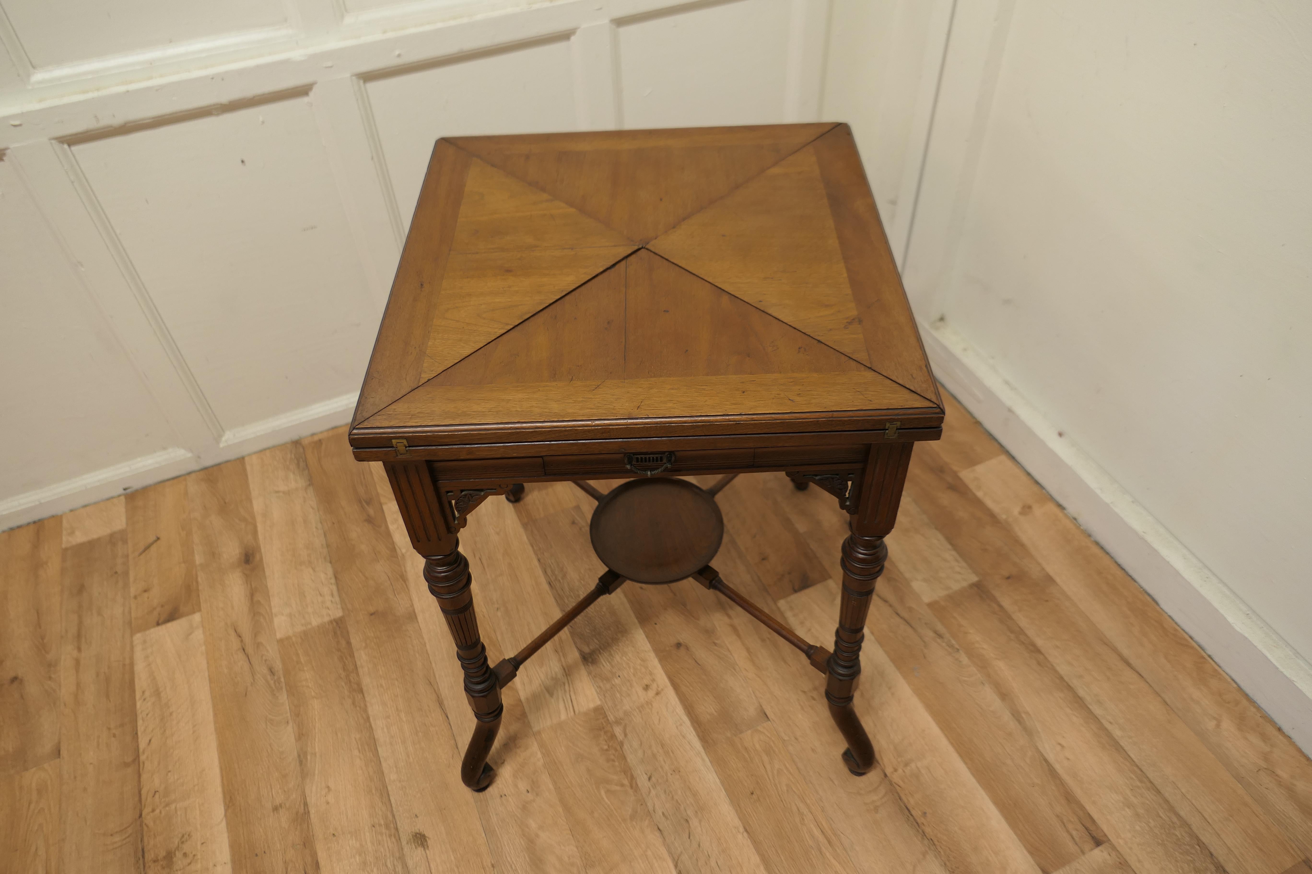 Victorian envelope card table with gaming wells

A beautifully designed piece, the sturdy 4 footed leg supports the 4 triangular hinged leaves which swivel and by pressing a button underneath they open out to reveal a good size card table with