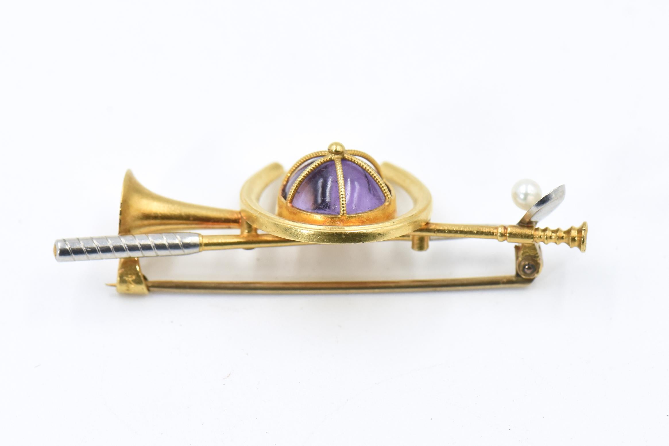 Fantastic Victorian equestrian pin that represents all types of equestrian activities - there is a jockey cap with a cabochon amethyst, a polo stick with a cultured pearl ball, a horse shoe and a hunting horn.  The back has a 