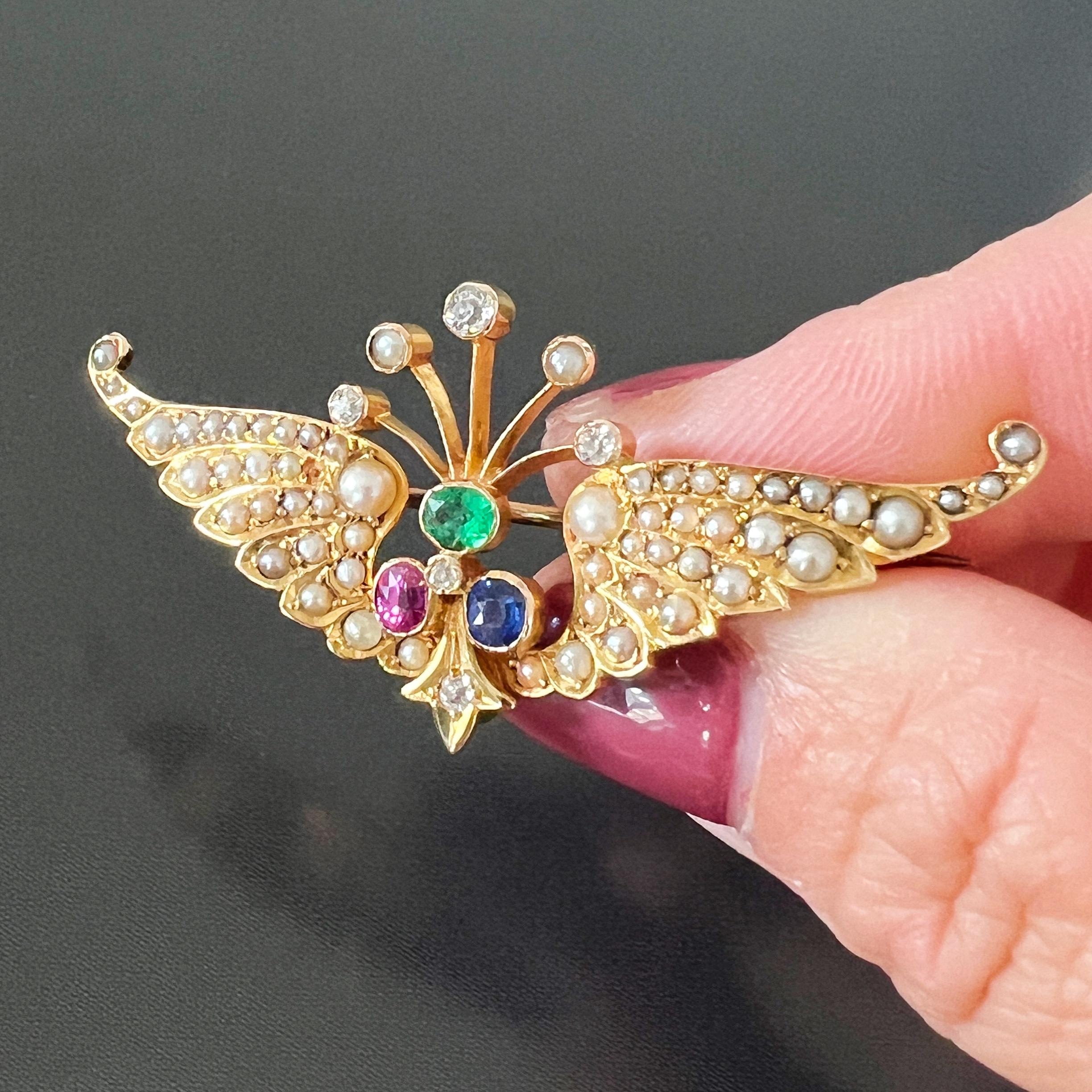 For sale an antique brooch made during the late 19th century, the Victorian era. It features a pair of wings made of 14K yellow gold. The wings are intricately designed and fully set with seed pearls, imitating the white color of the feathered