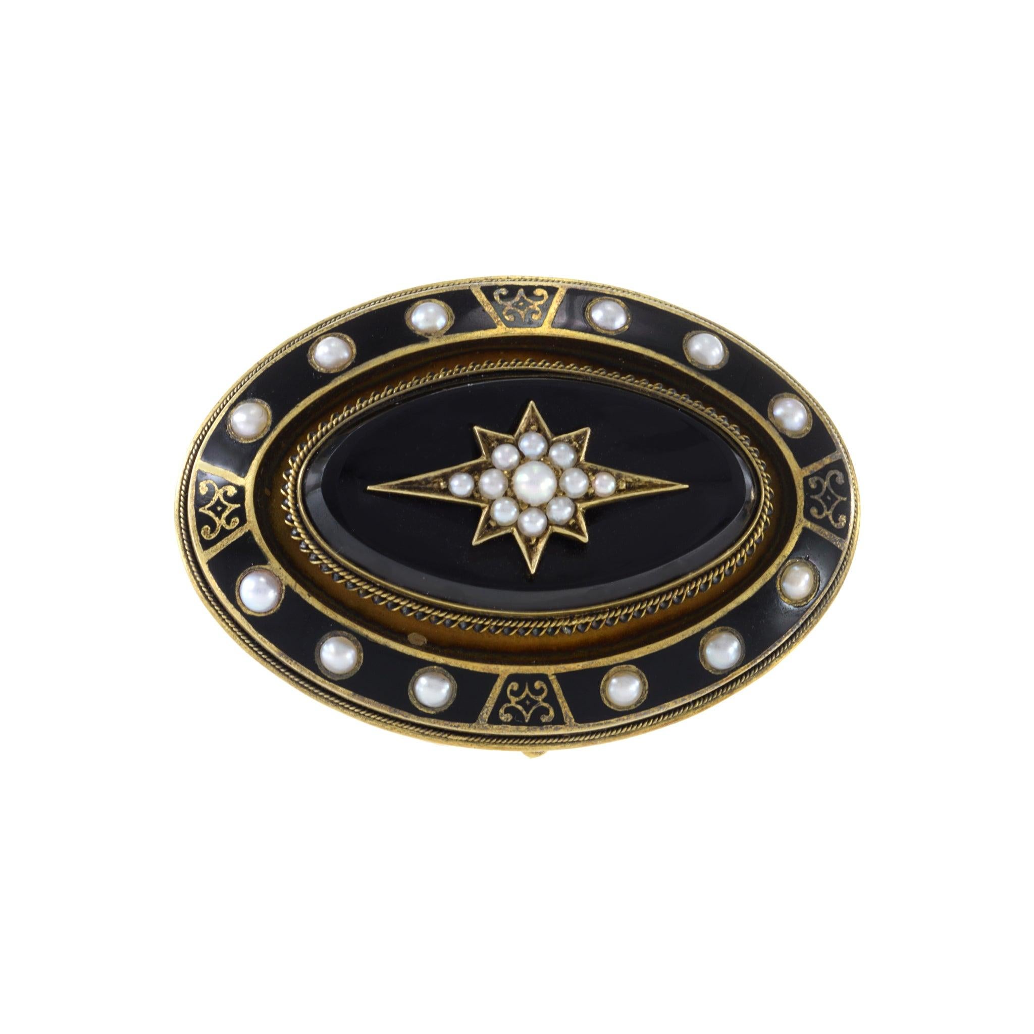 The elegant and timeless design of this antique Victorian era pin showcases a beautiful combination of 14KT yellow gold, black onyx and enamel, adorned with delicate seed pearls. This piece is perfect for adding a touch of sophistication and history