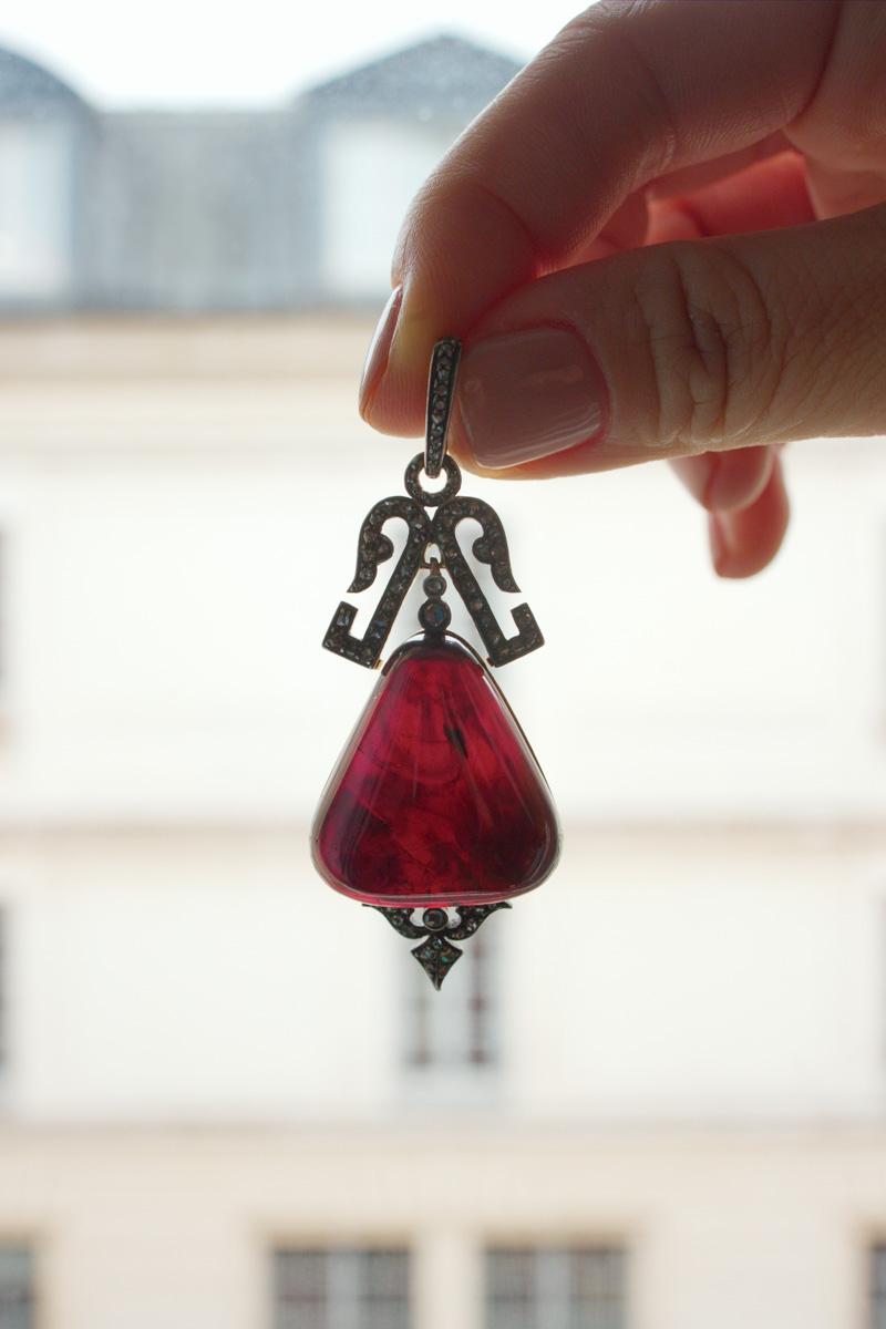 For sale a breathtaking Victorian era garnet and diamond pendant. This remarkable piece showcases a magnificent large garnet cabochon in a rare triangular shape. Also known as the 