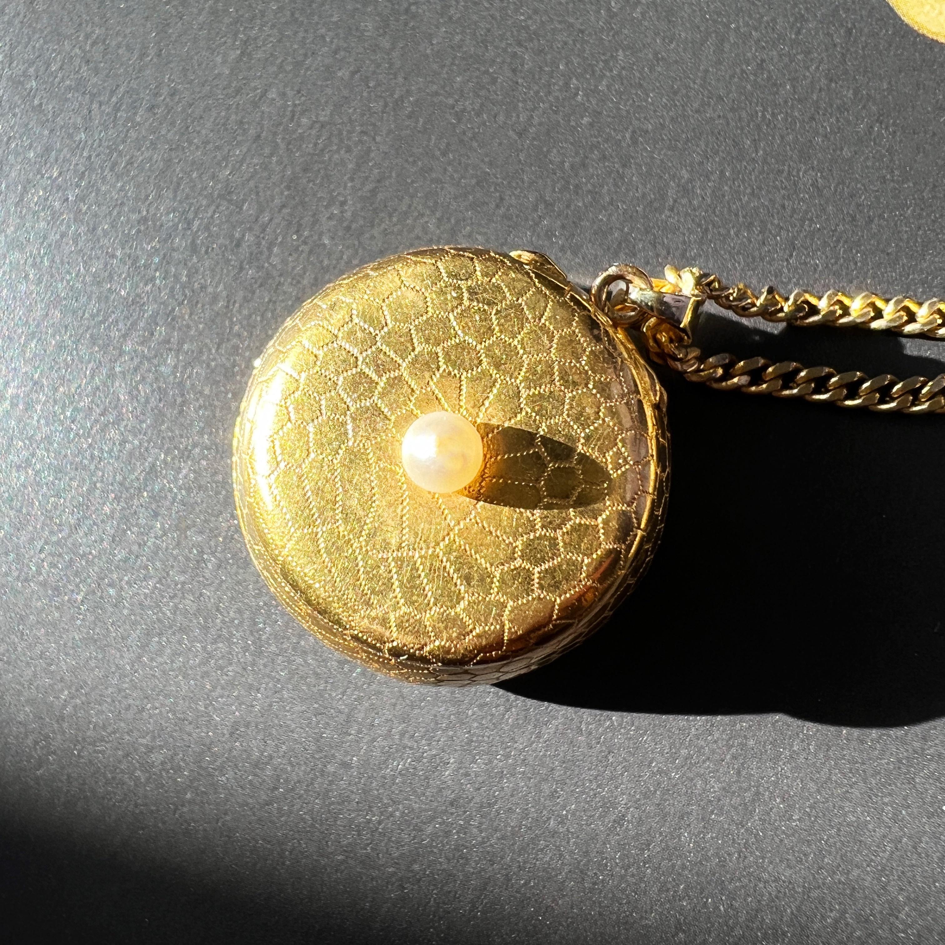 For sale a very rare French antique 18k gold perfume box pendant, adorned with intricate geometric gold motifs reminiscent of delicate honey patterns.

Unlocking its secrets reveals a hidden compartment separated by a refined floral window, once