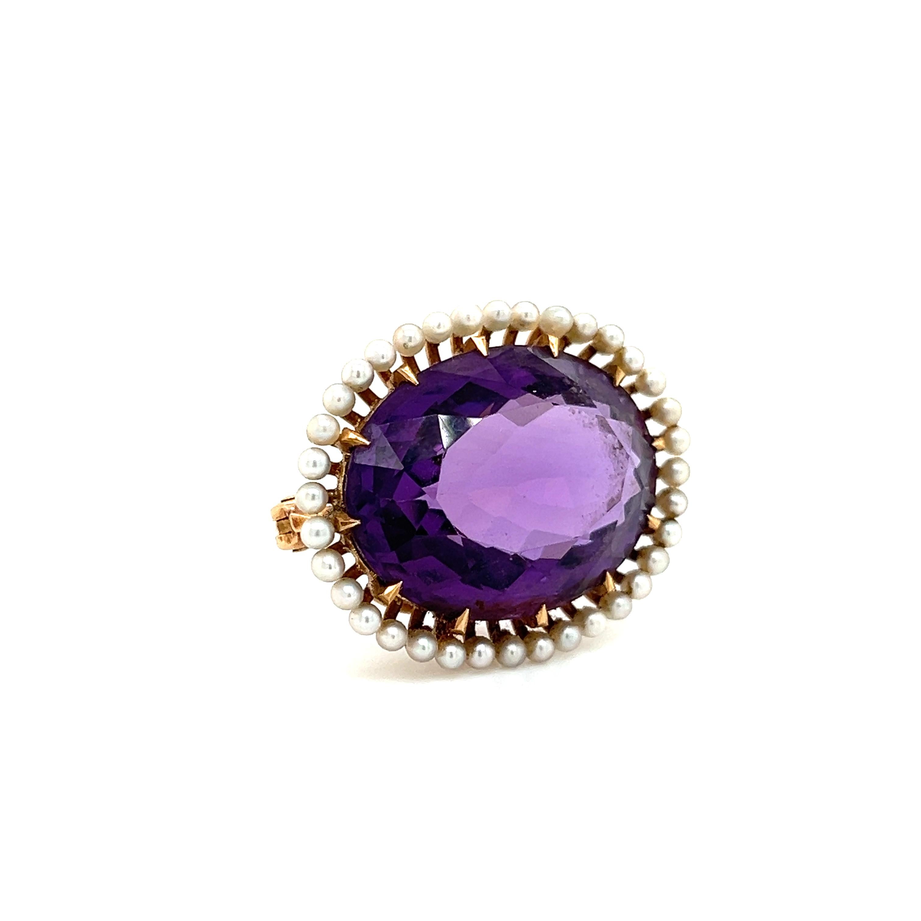 Beautiful pendant brooch crafted in 14k yellow gold. This elegant item highlights one oval shaped Amethyst gemstone set east/west. The gemstone is secured with razor sharp eagle talon prongs and accented with a natural seed pearl gemstone halo. The