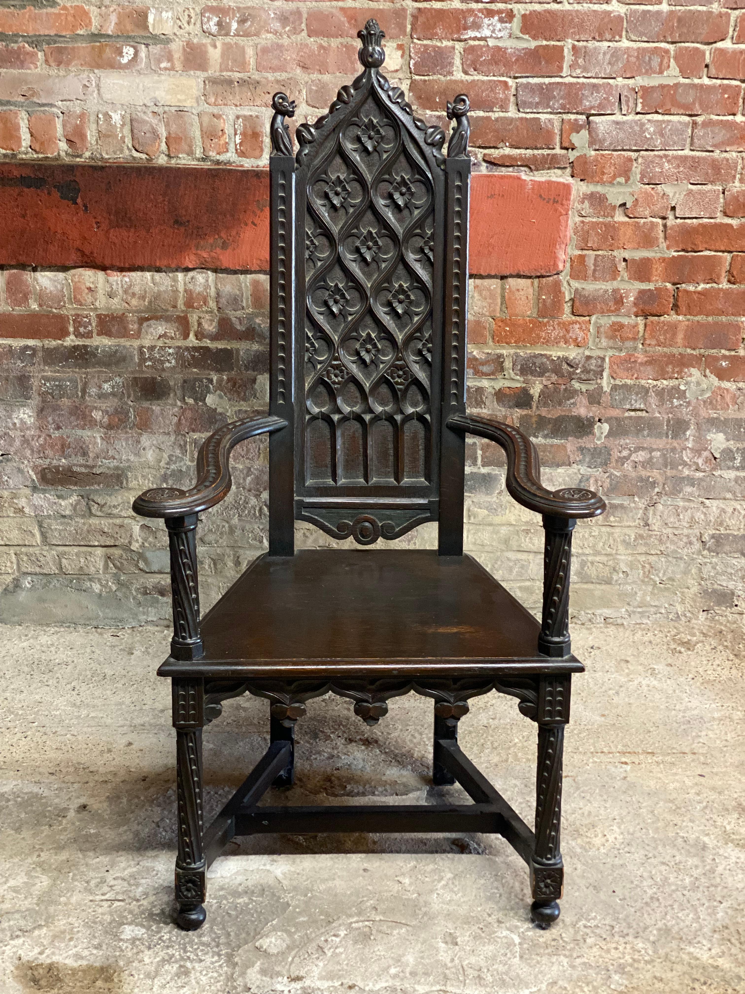 A wonderful high back carved 1890s Feudal Oak Carved armchair. This beautiful chair is sumptuously carved in the old English Heraldic style furniture. This piece has an amazing presence because it features carved dragons on the chair crest, chip