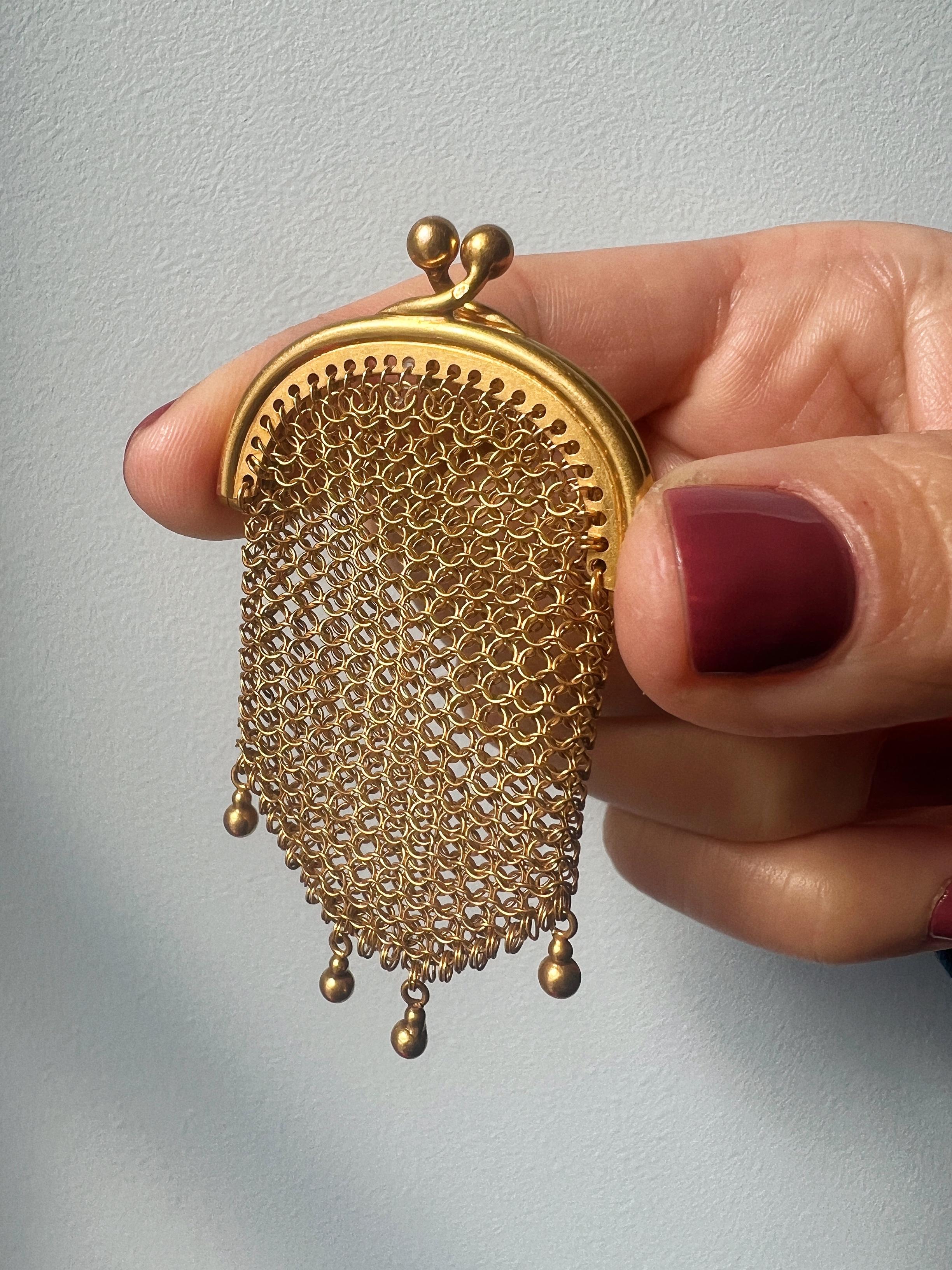 For sale an exquisite piece of jewelry from the 19th century, the Victorian era - a gold woven purse pendant. Crafted in 18K yellow gold and bearing the French owl hallmark for 18K gold, this French-made pendant is a testament to the exceptional