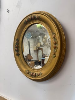 Victorian-Era Gilt Wood Framed Oval Mirror With Polychrome Floral Detail
