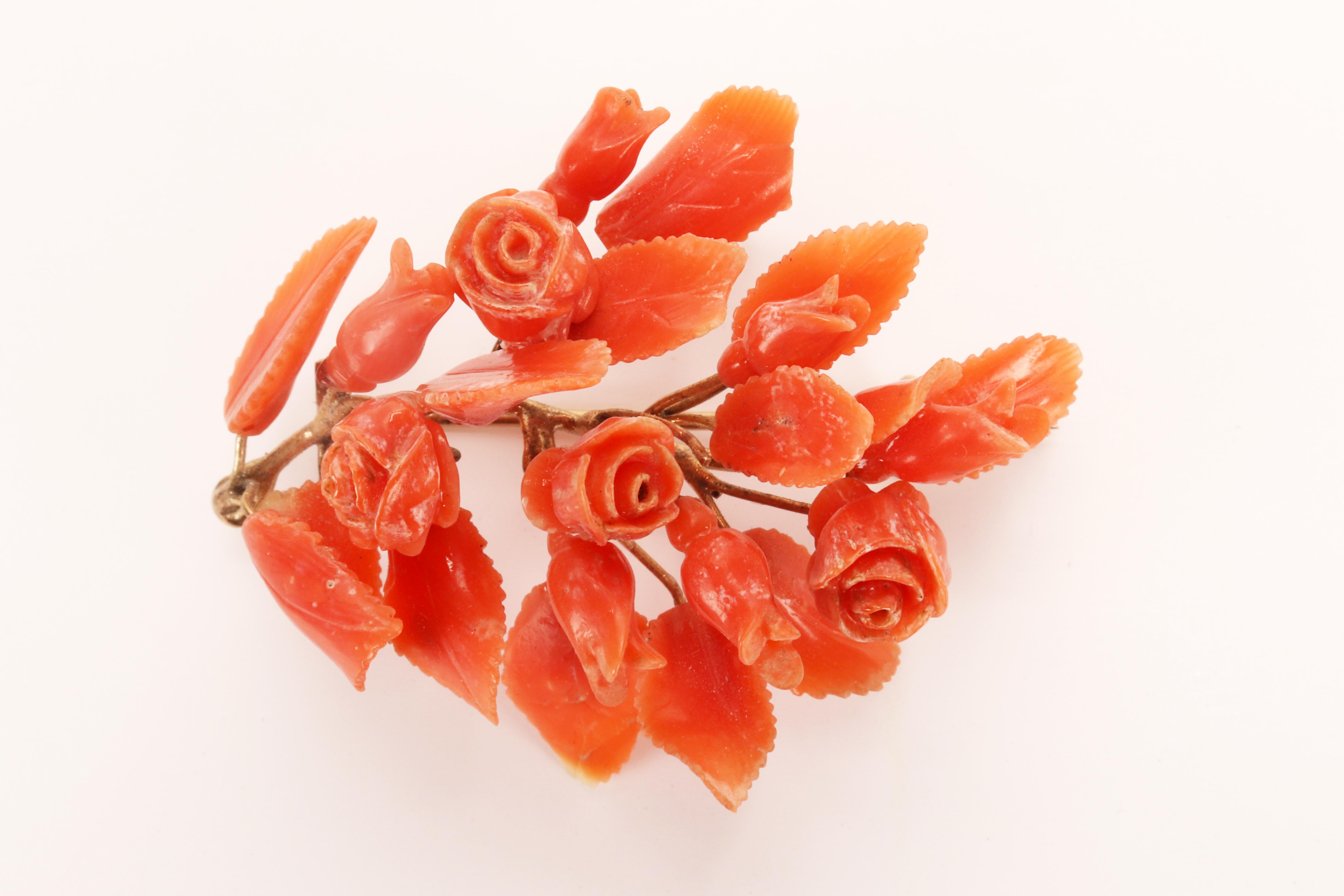 The Victorian era pin, is made out of 8 Kt.yellow gold and pink–orange Sciacca coral. A brunch of gold describes a curved motive with smaller brunches rising from it. At the end of each small brunch is connected a coral element, carved and engraved,