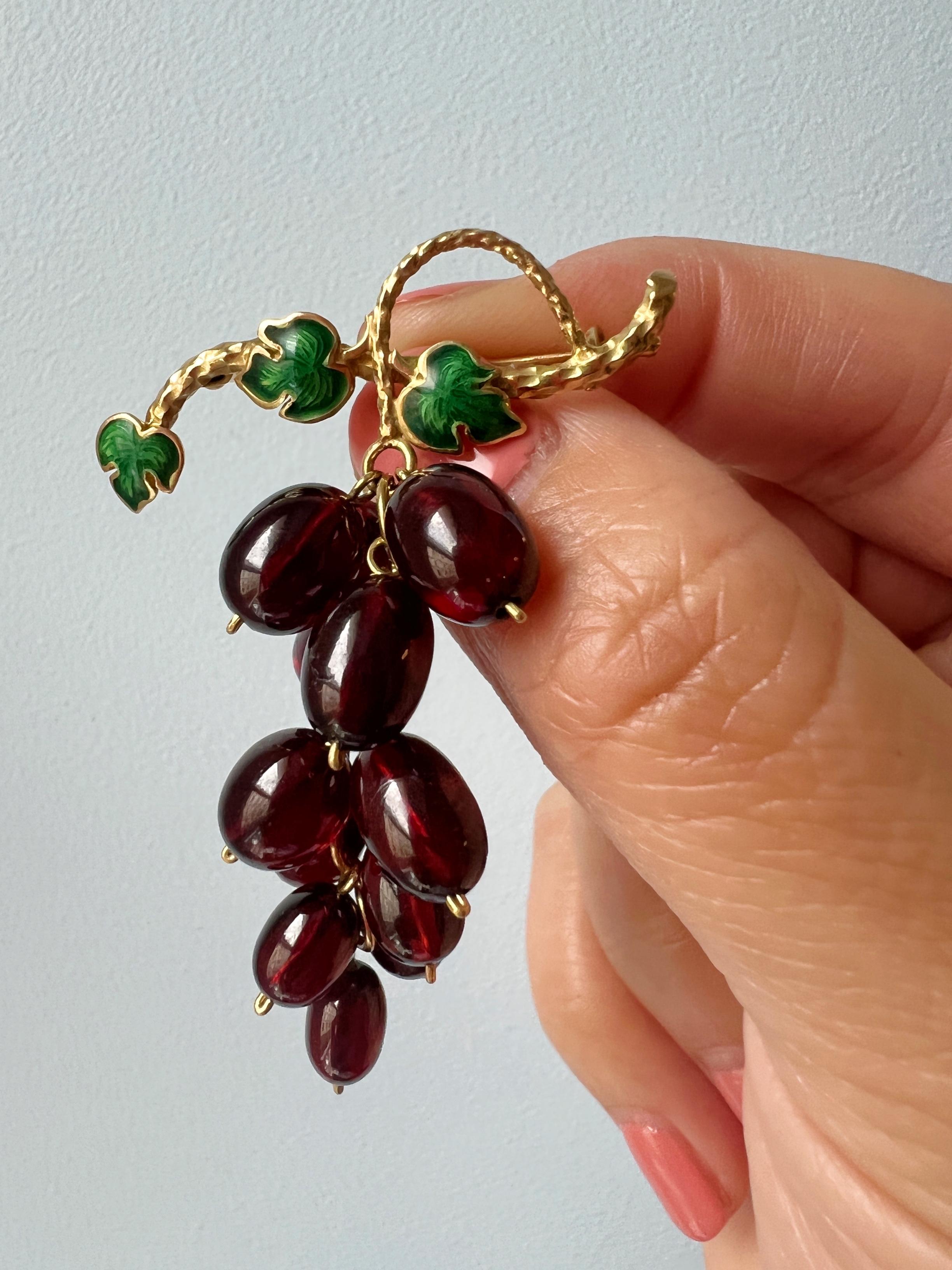 Sculptural, delightful and extremely skillfully crafted, this very rare and luxurious garnet grape brooch is among our favorite findings of the season!

This “delicious” brooch features a bunch of grapes made of 13 garnet cabochons in juicy deep red