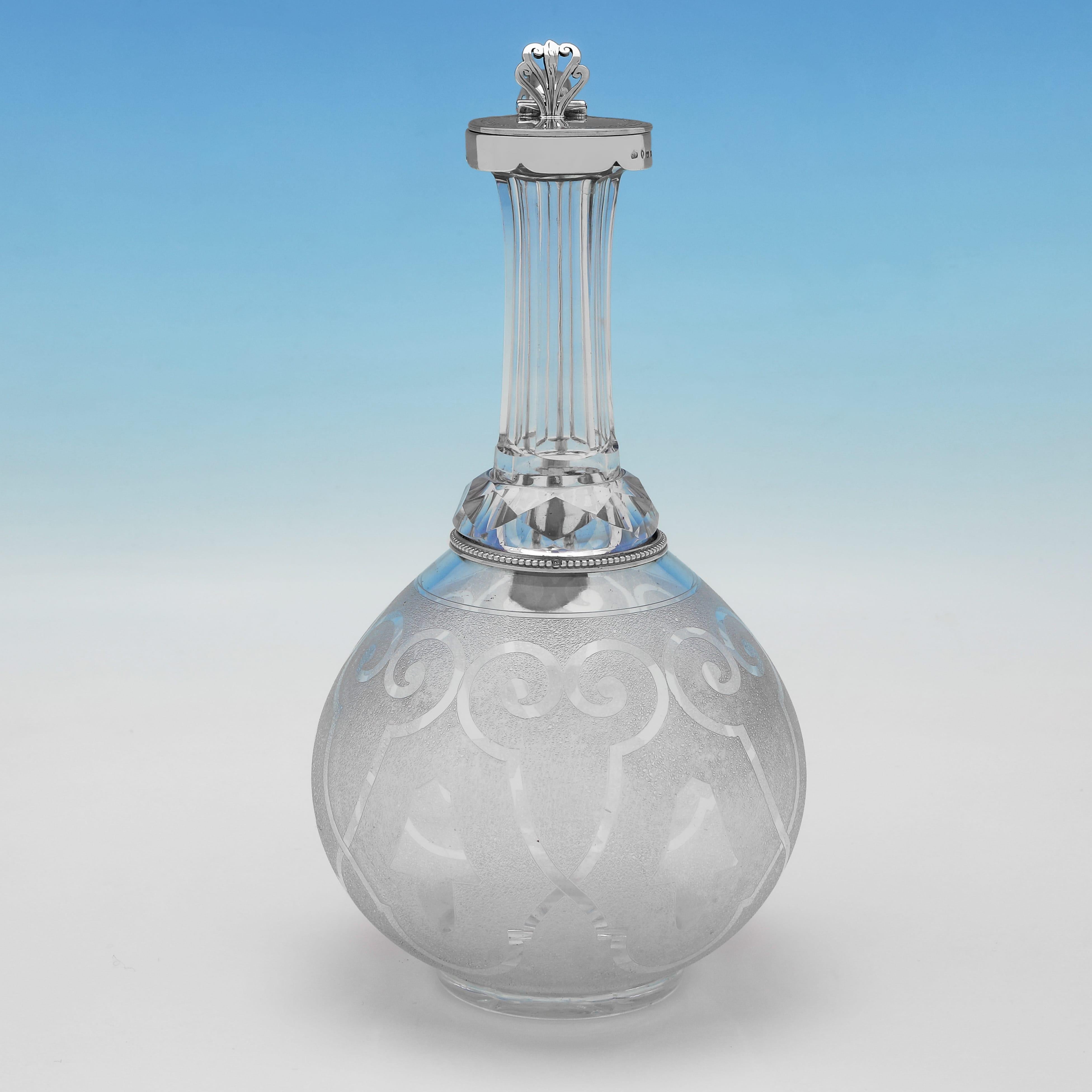 Hallmarked in Birmingham in 1867 by Gough & Silvester, this attractive, Victorian, Antique Sterling Silver & Glass Claret Jug, features an etched glass body, and a silver mount and handle. The claret jug measures 9.5