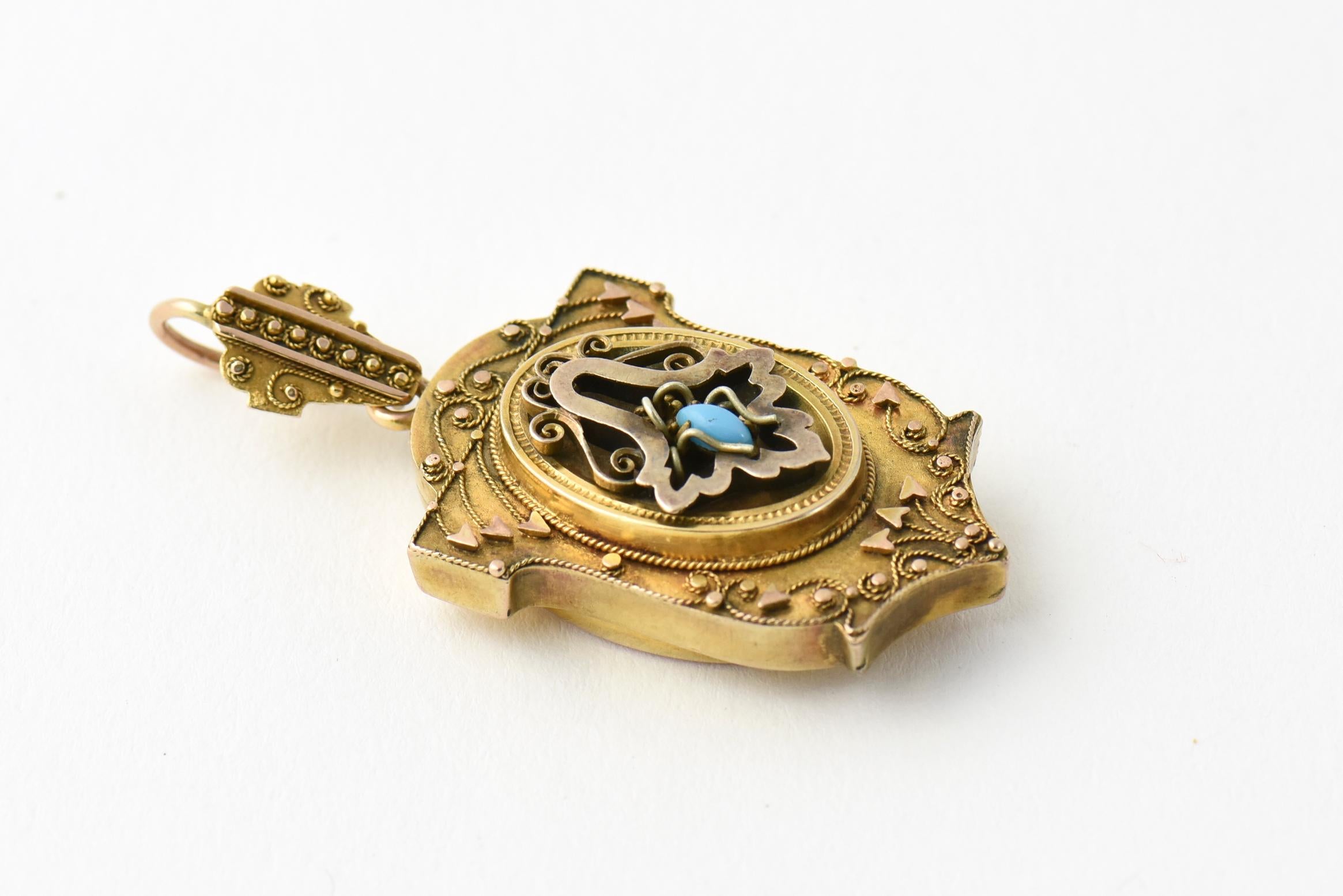 Victorian Etruscan Revival 10k yellow gold mourning locket with a removable back, originally intended for placing a lock of hair. The front area features a spider with a turquoise stone body, symbolizing wisdom and hard work. Age wear, tarnished,