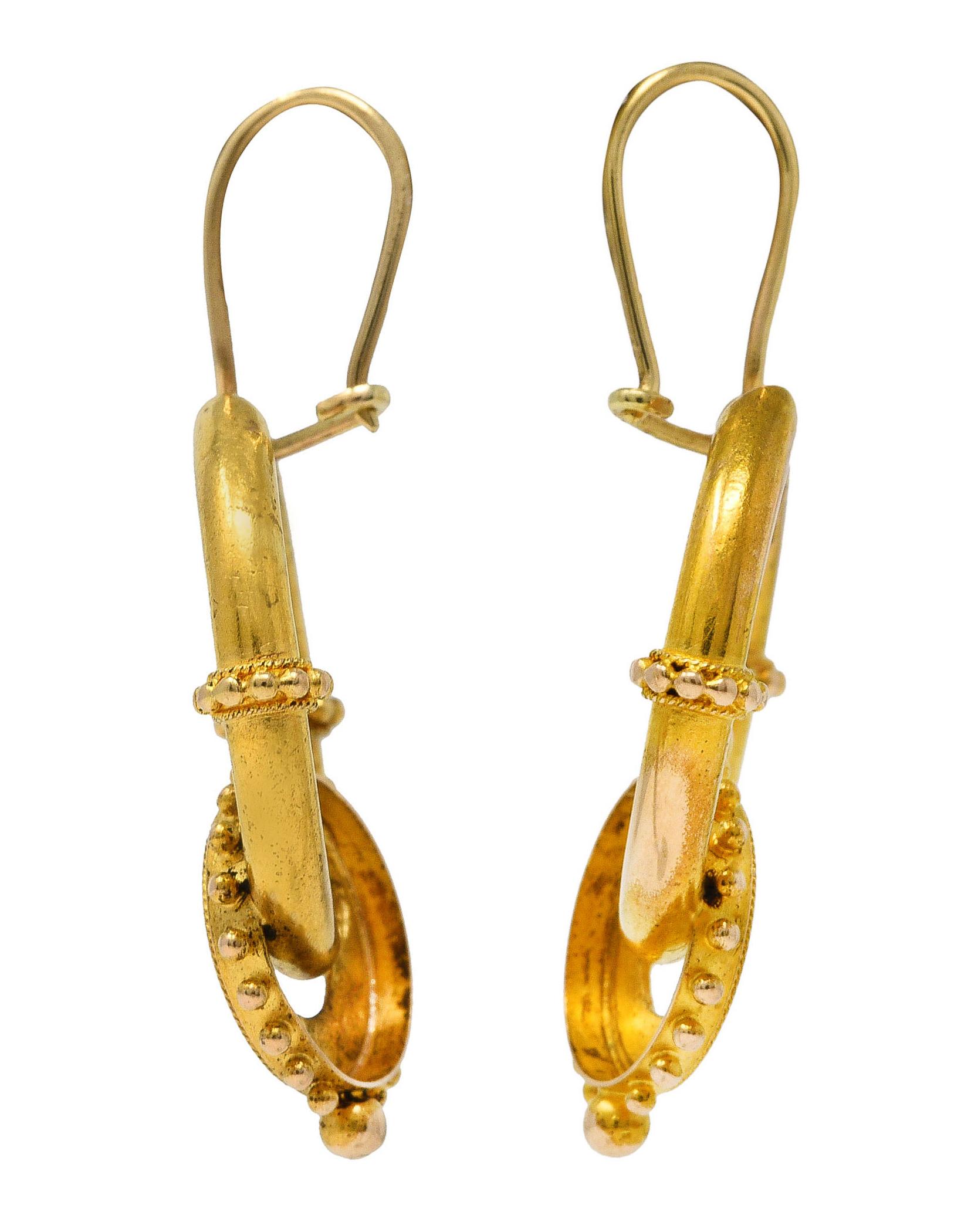 Earrings are designed as round gold hoops with smaller interlocked hoops. With decorative gold beading and twisted rope motif throughout. Completed by wire ear-hooks. Tested as 14 karat gold. Circa: 1870's. Measures: 7/8 x 1 1/2 inches (including