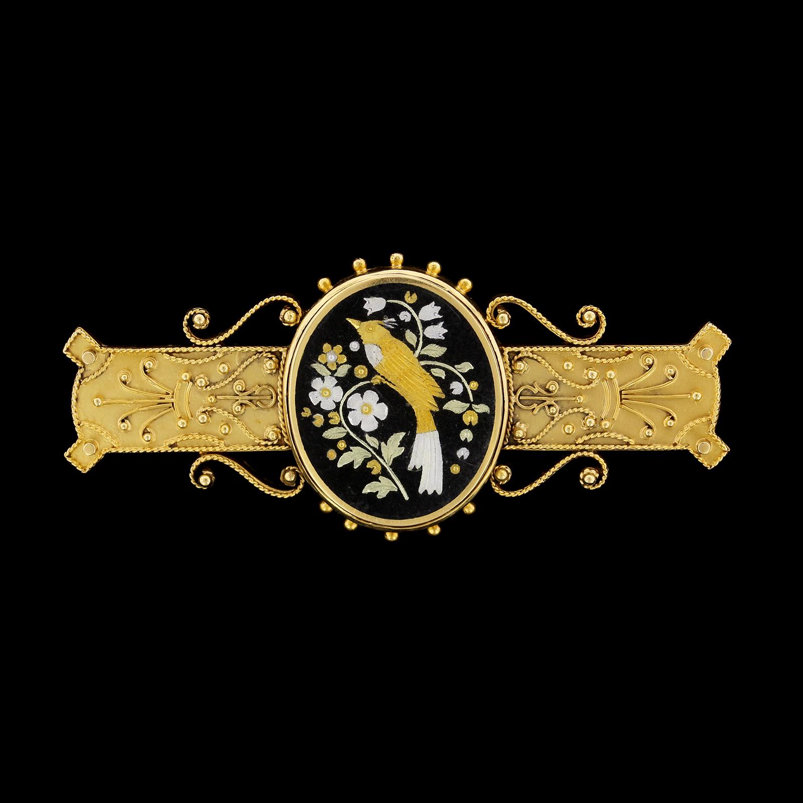 Victorian Etruscan Revival 18K Yellow Gold Damascene Pin. The pin is set with an
Damascene panel depicting a bird amongst flowers with ropetwist and beaded
accents, length 1 3/8