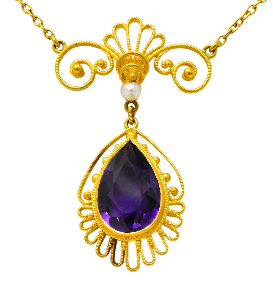 Centering a pear cut amethyst weighing approximately 3.50 carats, transparent medium royal purple in color

Bezel set in decorative drop with gold bead and scallop details

Accented by a freshwater natural pearl measuring approximately 2.7 mm, white