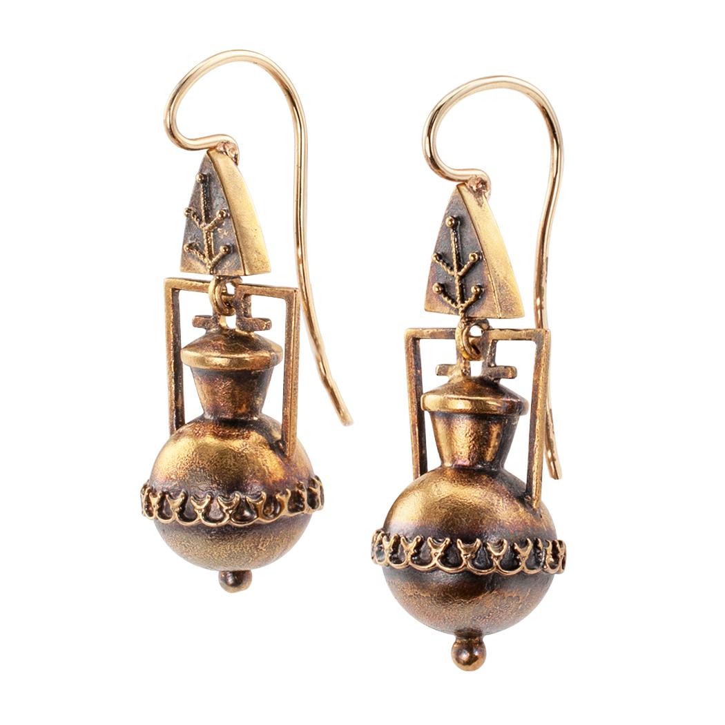 Victorian Etruscan revival amphora gold pendent earrings circa 1890. The matching designs comprising a pair of round-bottomed amphora jars, suspended from foliar inspired surmounts, crafted in 14-karat gold. We love the perfectly balanced look of