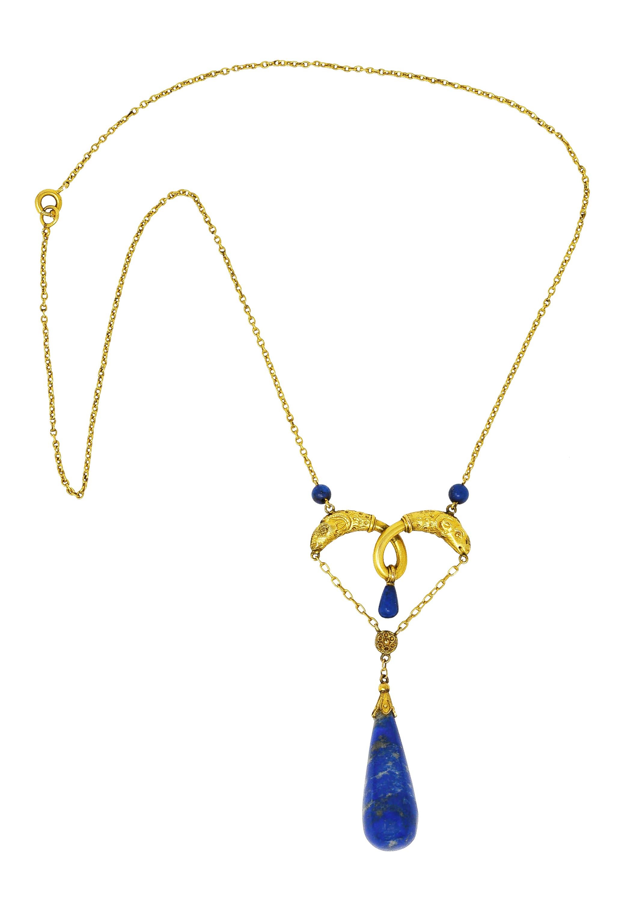 Necklace features a swagged central station with twisted wire terminating as two rams' heads. With textured horns and fur - suspending a lapis lazuli teardrop shaped bead from a floral surmount. Measuring 11.0 x 22.0 mm - opaque ultramarine blue
