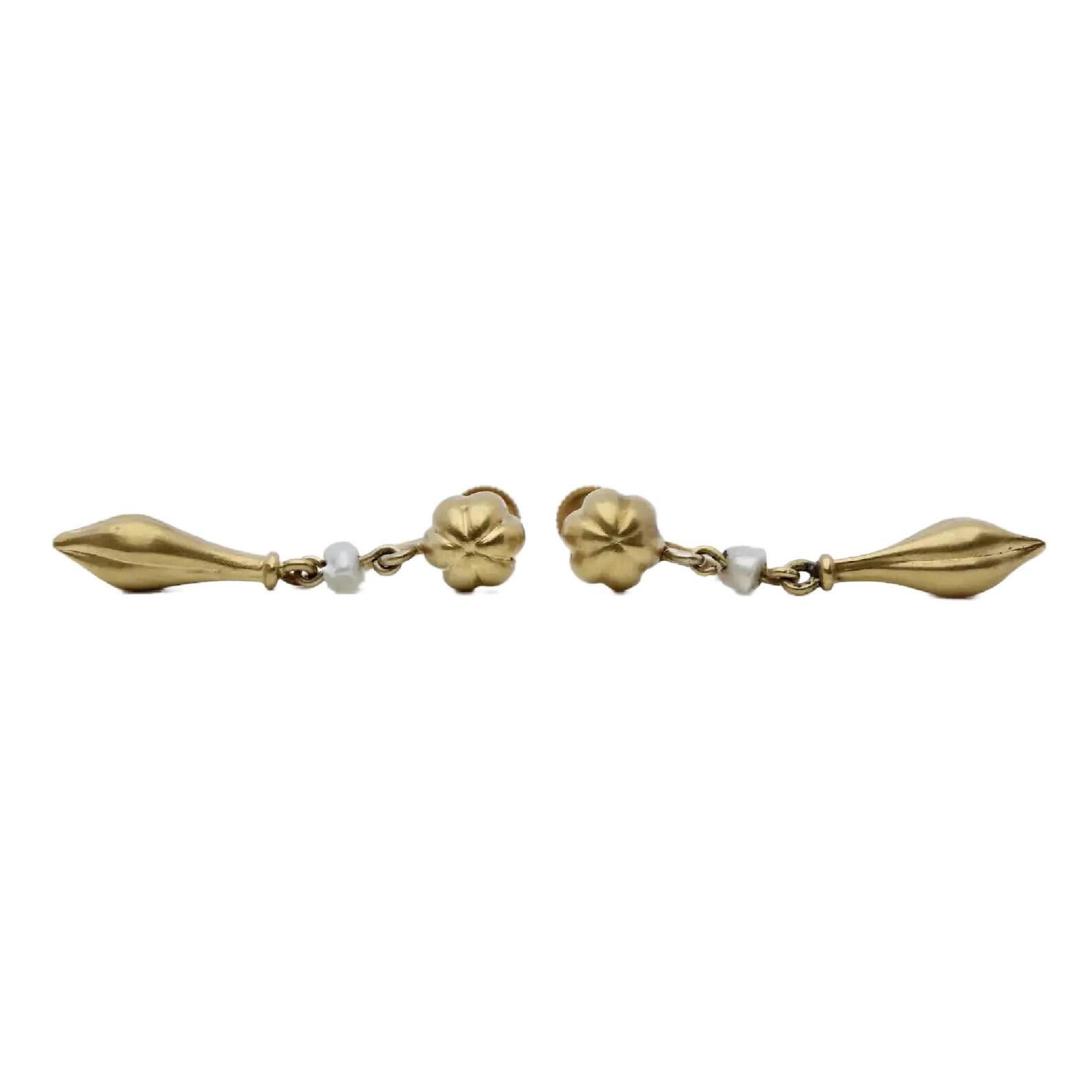 A pair of victorian period, Etruscan revival earrings in 14 karat yellow gold. Featuring a tufted yellow gold bead at top from which suspends a natural pearl, and a yellow gold urn. Measuring 3mm wide, the pearls are of natural salt water