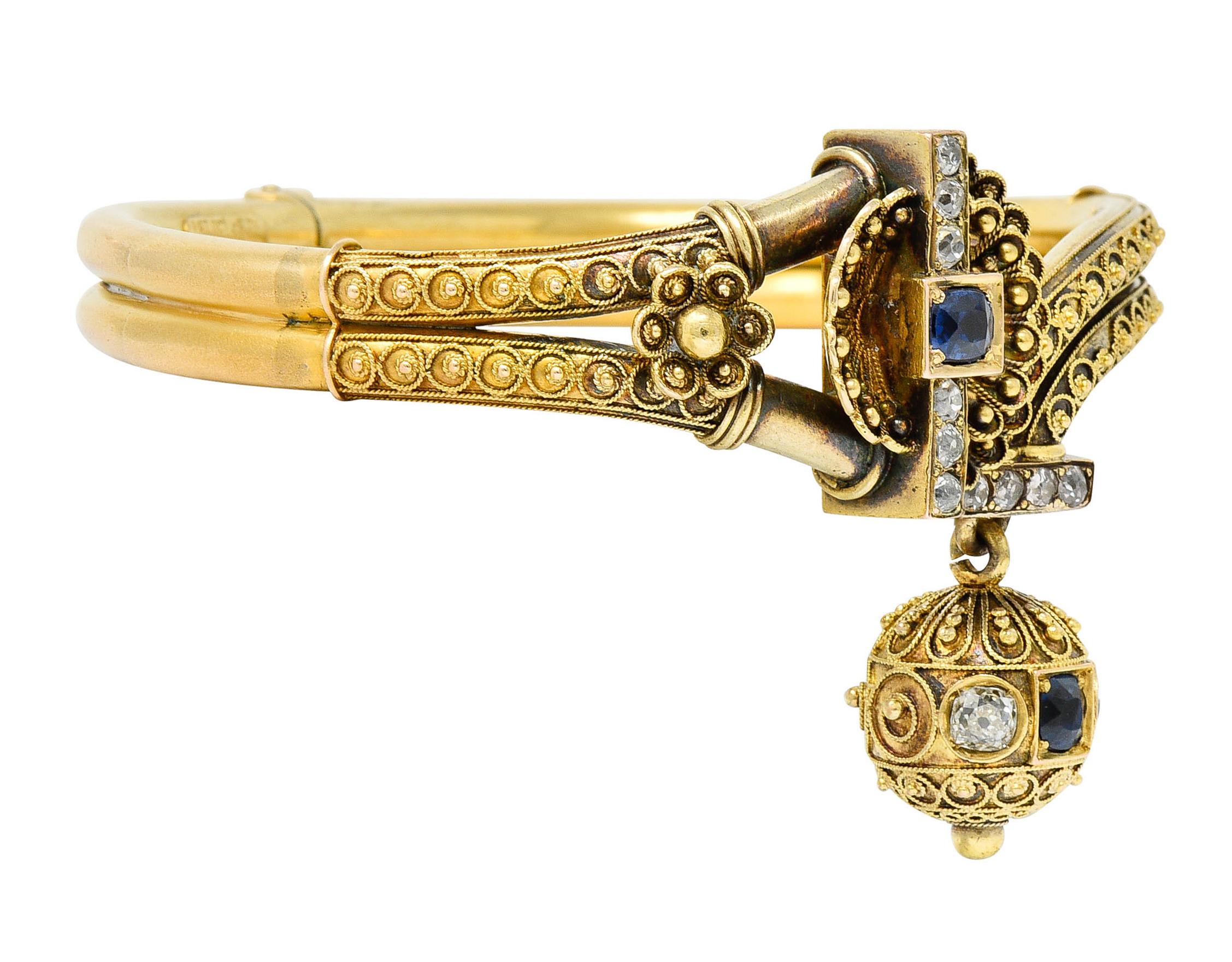 Hinged bangle bracelet terminates as a cupped clamshell and an articulated ball charm

Bypass in style with twisted rope, gold bead, and floral details throughout

Ball and shell are accented by sapphires and diamonds

Sapphires are medium dark