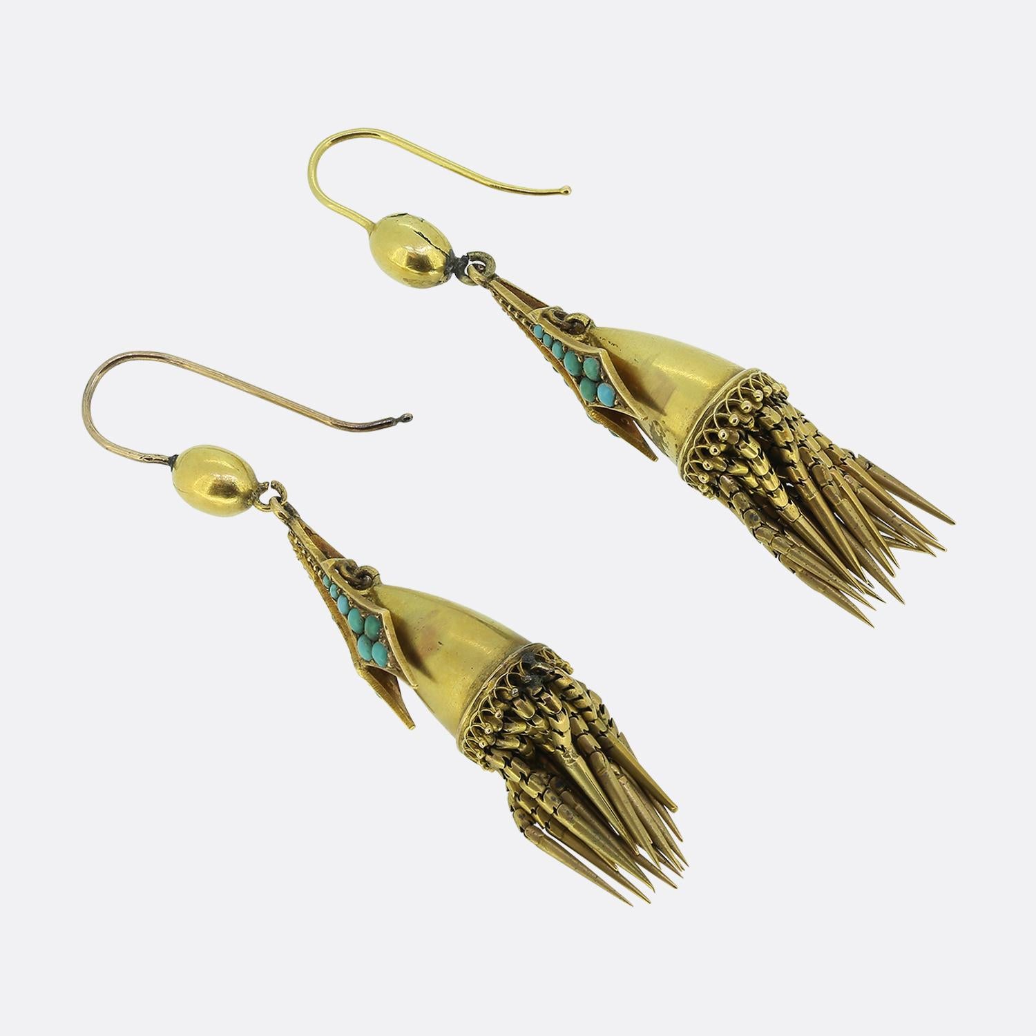 This is a wonderful pair of Victorian 18ct yellow gold drop earrings. The earrings are crafted in an etruscan style and feature blue turquoise stones and fine open work. At the bottom of the of the earrings in typical etruscan style their are gold