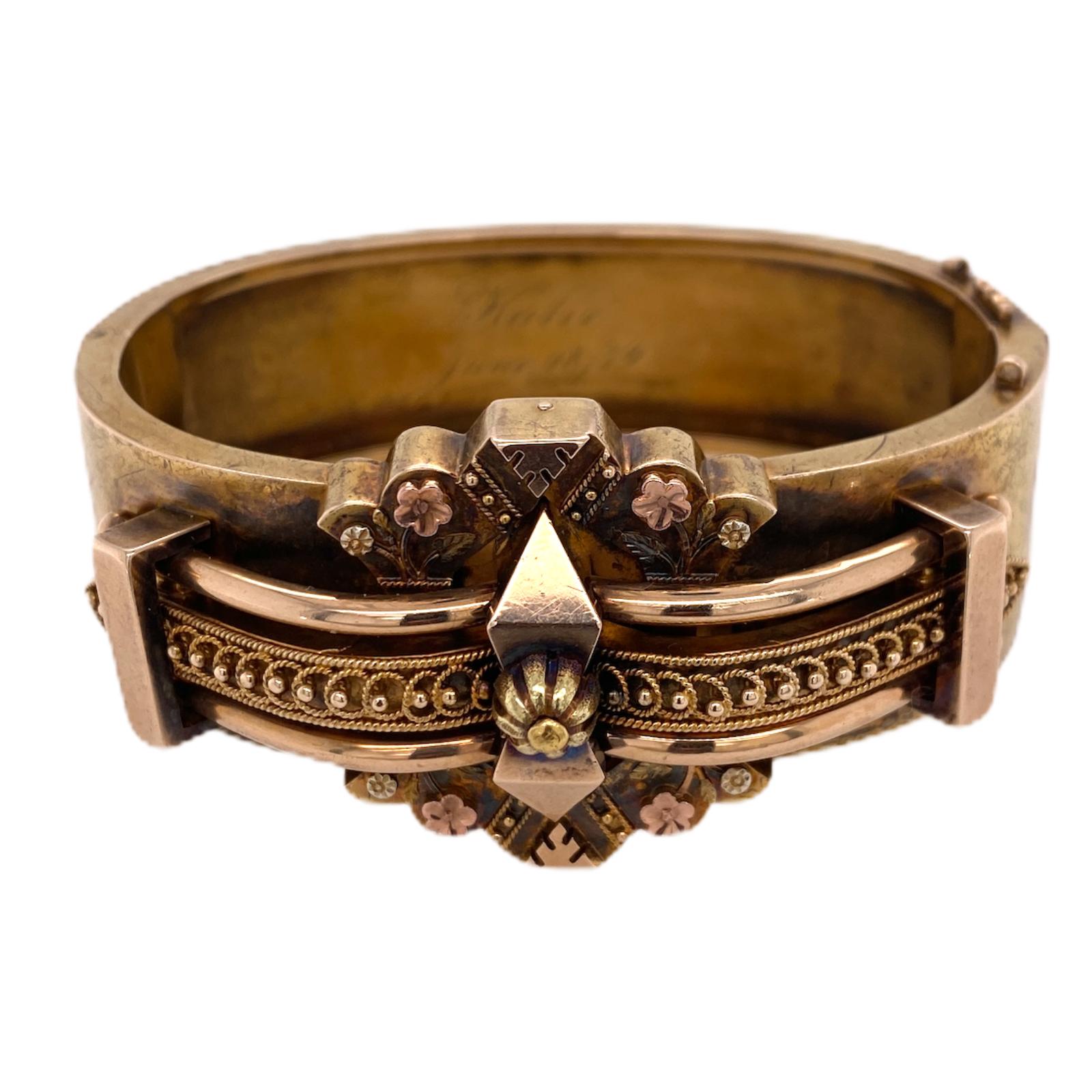 Fabulous original Victorian hinged bangle fashioned in 15 karat yellow gold. The Etruscan style bangle measures 7.0 inches in circumference, 2.25 inches in diameter, and 1.0 inch in width. I have not polished the bangle in order to keep the original