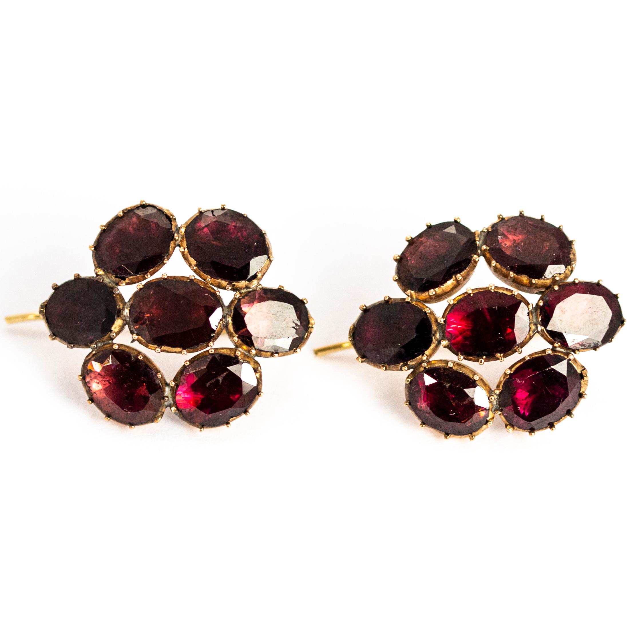 These absolute stunners have a wonderful sparkle and the flat cut garnets are a really lovely deep red colour. The earring backs are attached at the centre of the cluster which means the earrings sit close to the lobe. 

Dimensions: 21.5mm x 26mm