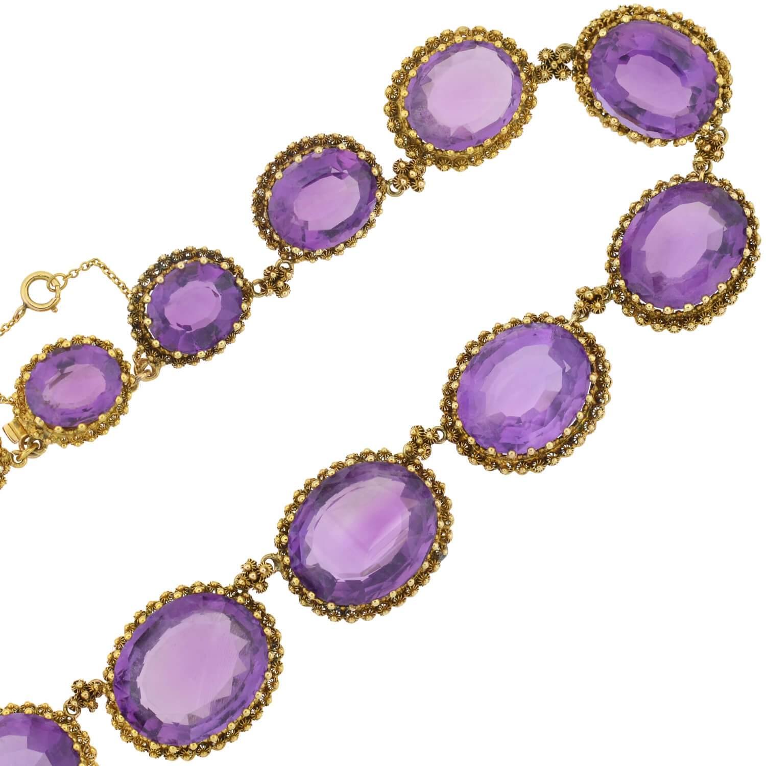 A dramatic and breathtaking amethyst link necklace from the Victorian (ca1880) era! This stunning piece is comprised of 16 faceted amethyst stones resting in an ornate 15kt yellow gold setting. The oval-shaped stones are of exceptional quality, and