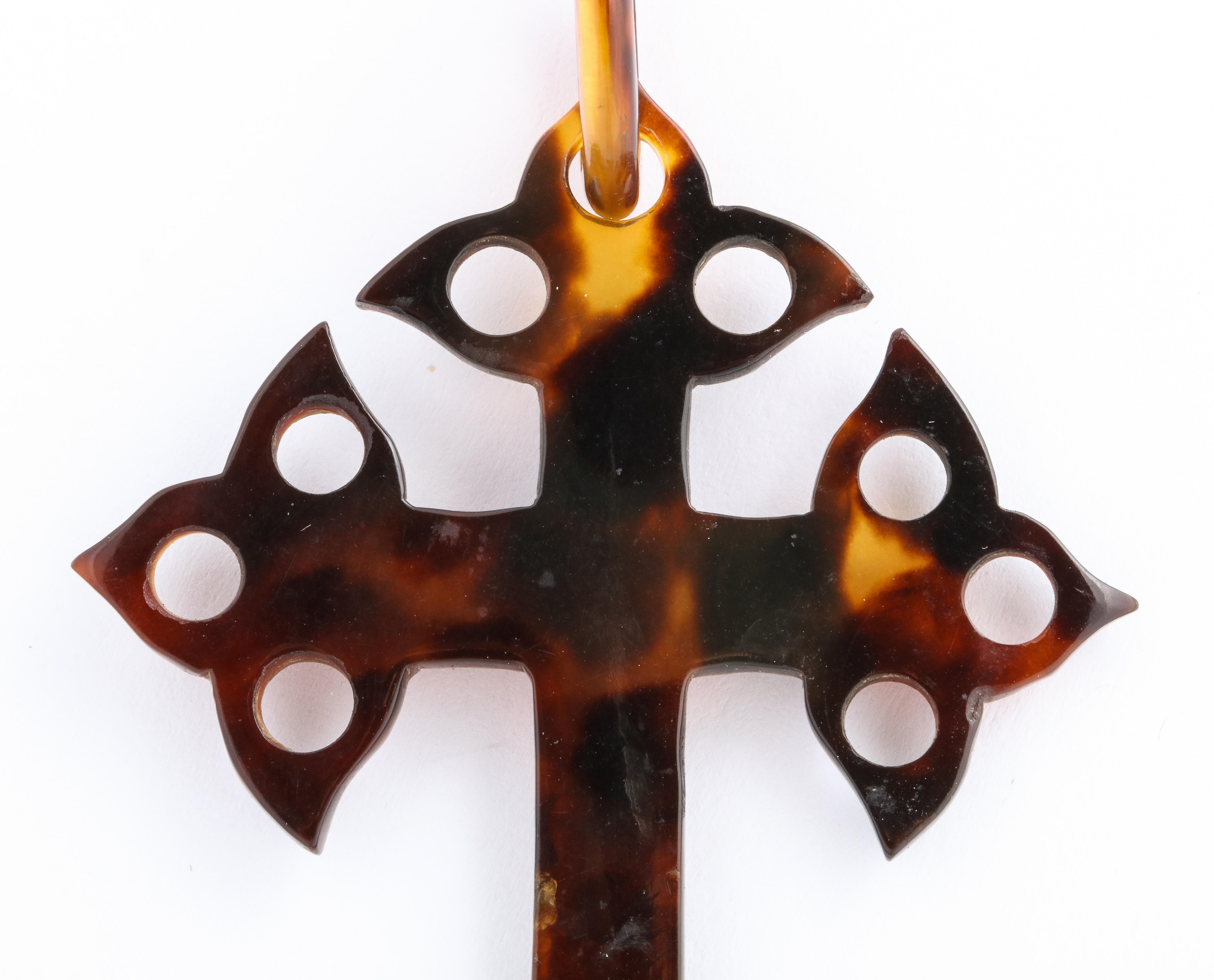 Amazing, think of it, how this tortoise shell cross is carved with circles cut away and even the loop cut out with a crack. The cross has survived and reaches us in excellent condition. There are no dibs or bites. Just a lovely form, buttery soft