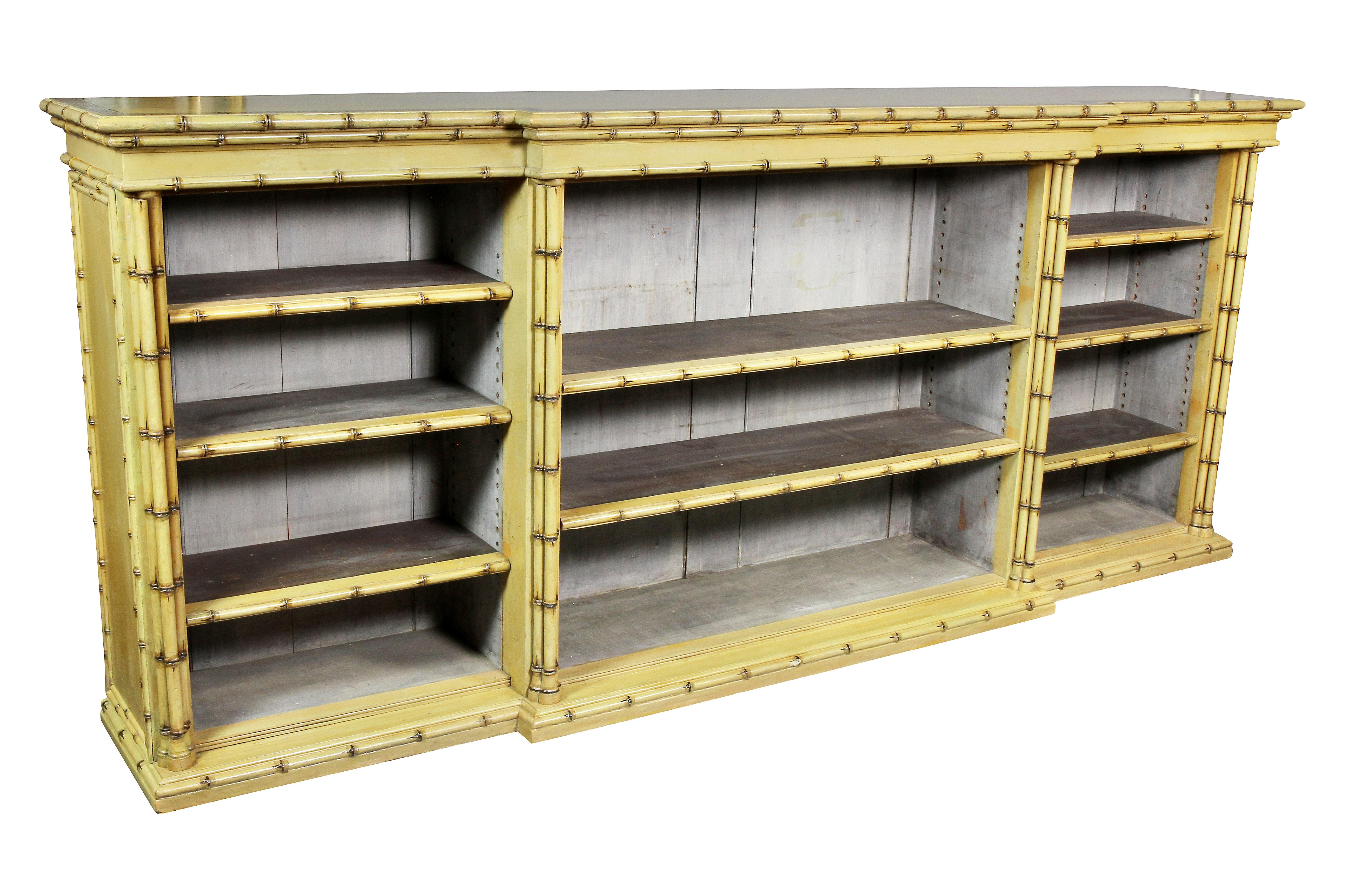 Breakfront top with painted Greek Key decoration over an open bookcase section with carved wood faux bamboo, fitted with shelves, conforming plinth base. Collection W. Hodgins, Boston. Original yellow paint professionally restored.