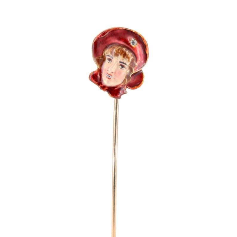 Aston Estate Jewelry Presents:

A beautifully hand painted enamel figural stick pin. Depicting a bright smiling young girl with red scarf around her neck, and a ruby red bonnet. Accented by a singled 0.04 carat old mine cut diamond set in her