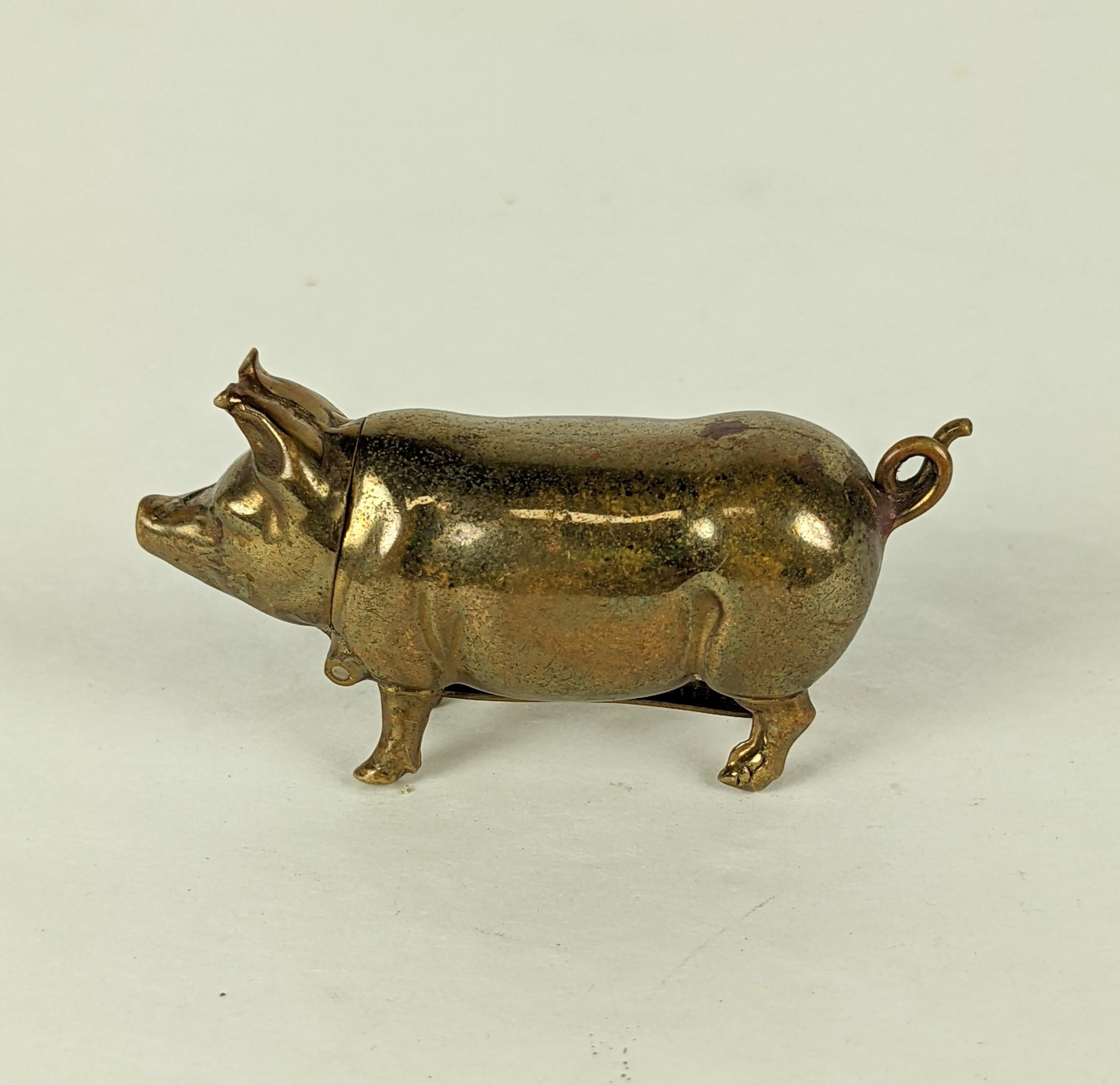 Charming Figural Pig Match Safe in brass from the late 19th Century, the pig's head opens to hold matches and there is a striking area under the belly to light the matches. Circa 1900.  Approx 2
