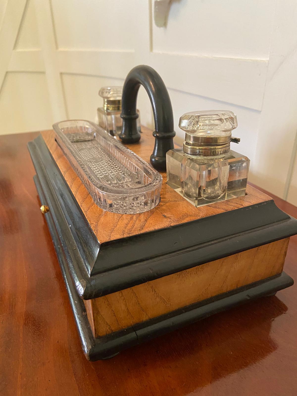 Antique Victorian figured walnut free standing desk set with the original pair of glass inkwells and pen tray sitting on a lovey quality figured mahogany writing box with a moulded edge. It boasts a quaint arched shaped carrying handle, one long