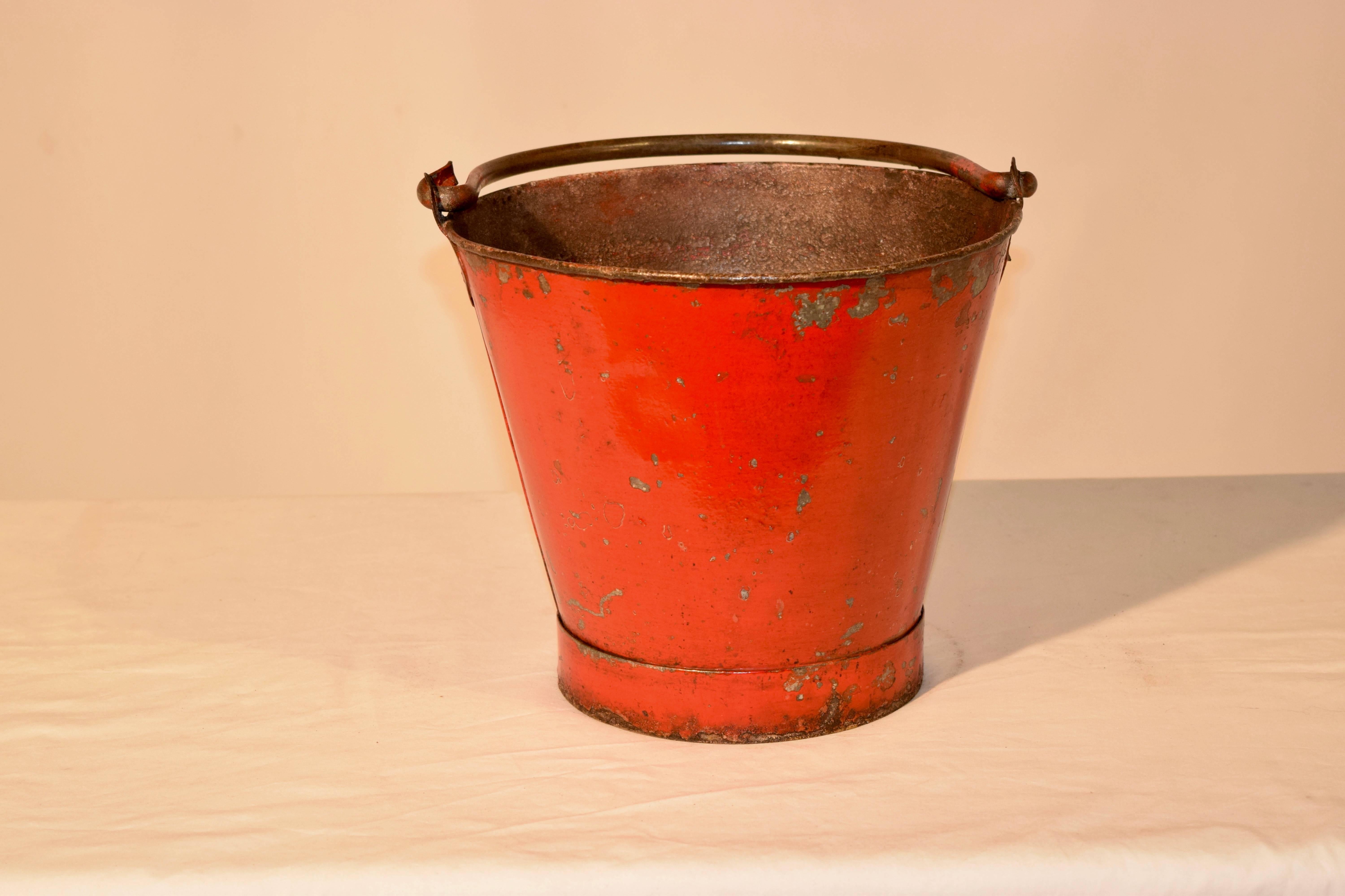 Late 19th century fire bucket with hand-forged handle and original paint.