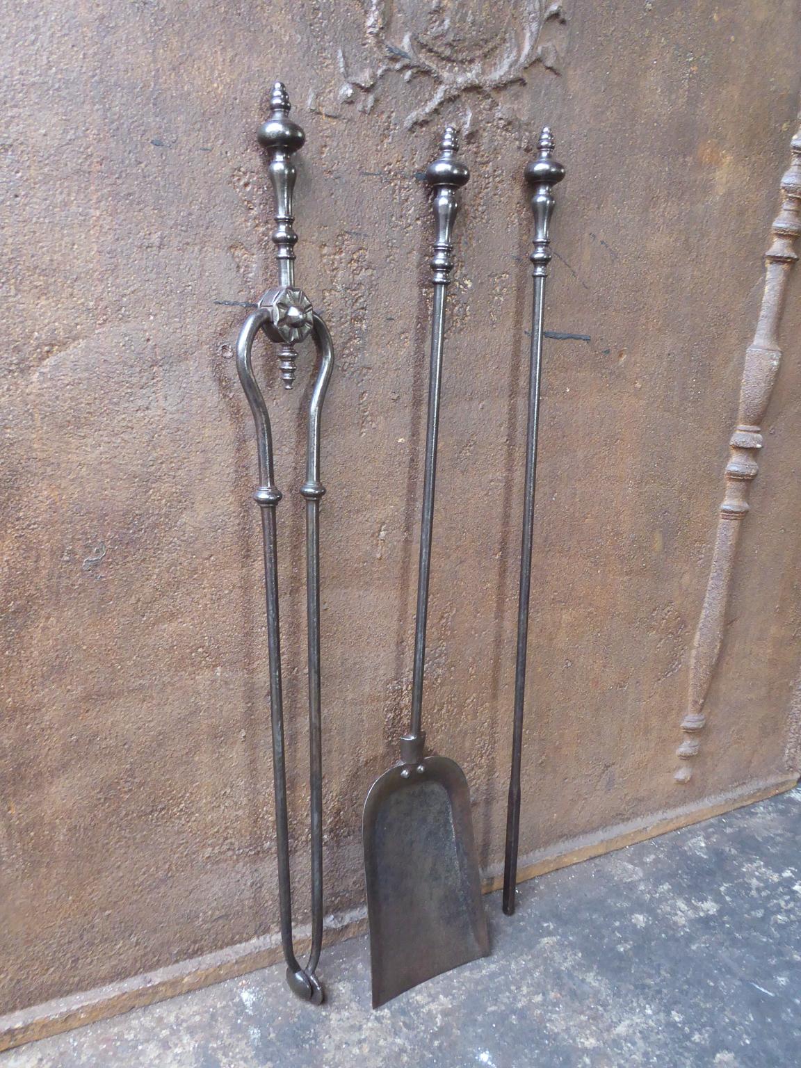19th century English Victorian set of fireplace tools. The tools are made of wrought iron. The set is in a good condition and is fully functional.

We have a unique and specialized collection of antique and used fireplace accessories consisting of