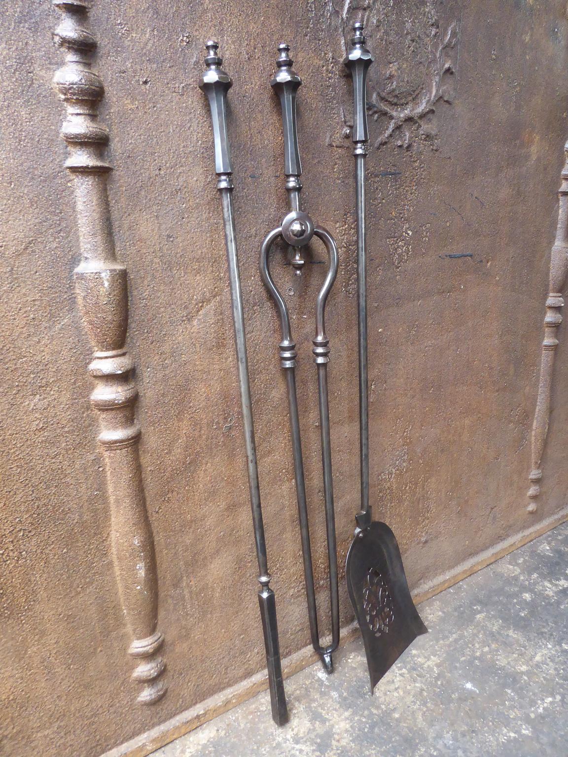 Beautiful 19th century English Victorian set of of three tools with ring-banded shafts, knopped finial handles and a finely pierced & cut shovel. The  fire tools are made of wrought iron. The set is in a good condition and is fully functional.