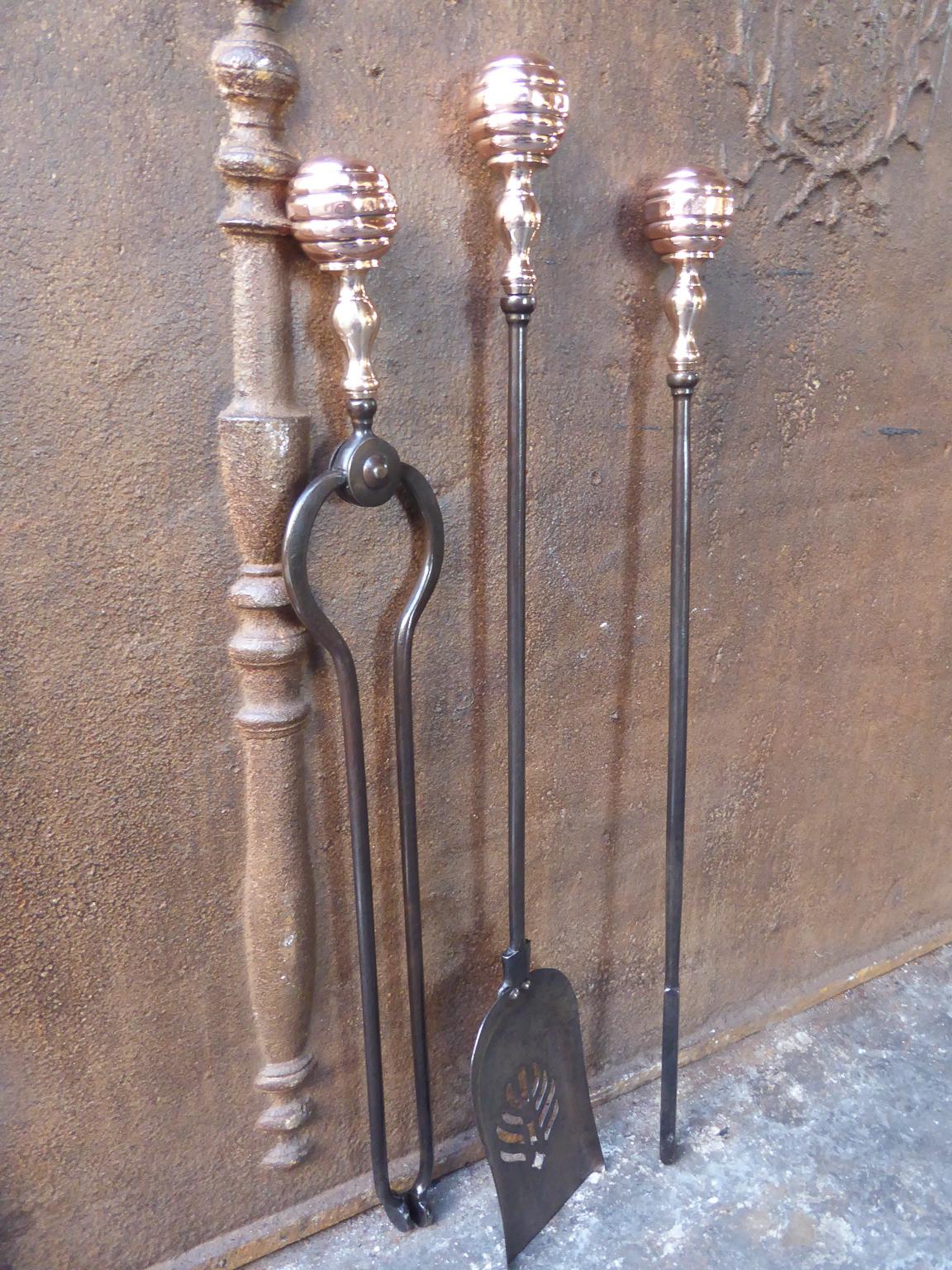 19th century English Victorian set of three tools with knobbed handles and a finely pierced and cut shovel. The fire tools are made of wrought iron and polished copper. The set is in a good condition and is fully functional.

