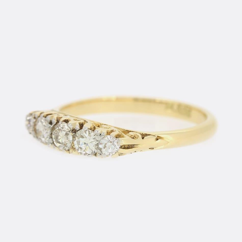 This is an exquisite 18ct yellow gold late Victorian five stone ring. The central diamond is an old cut and is approximately 0.15 carats. The diamonds on either side then graduate in size and are excellently matched for colour and clarity. The