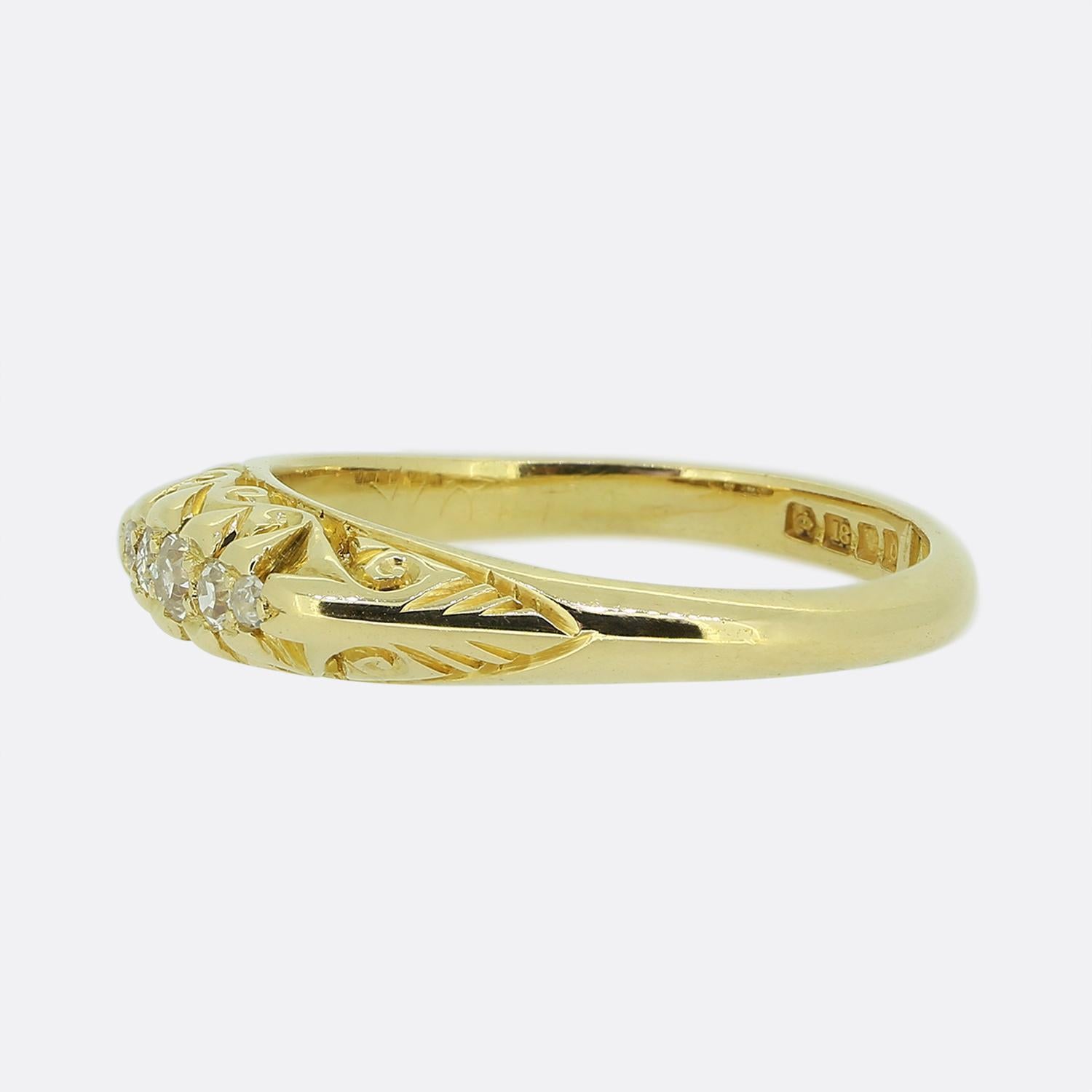 Here we have a Victorian five-stone diamond ring. This piece has been crafted from a rich 18ct yellow gold and features five round faceted old cut diamonds which graduate in size towards the centre in a single line formation. The ring also showcases