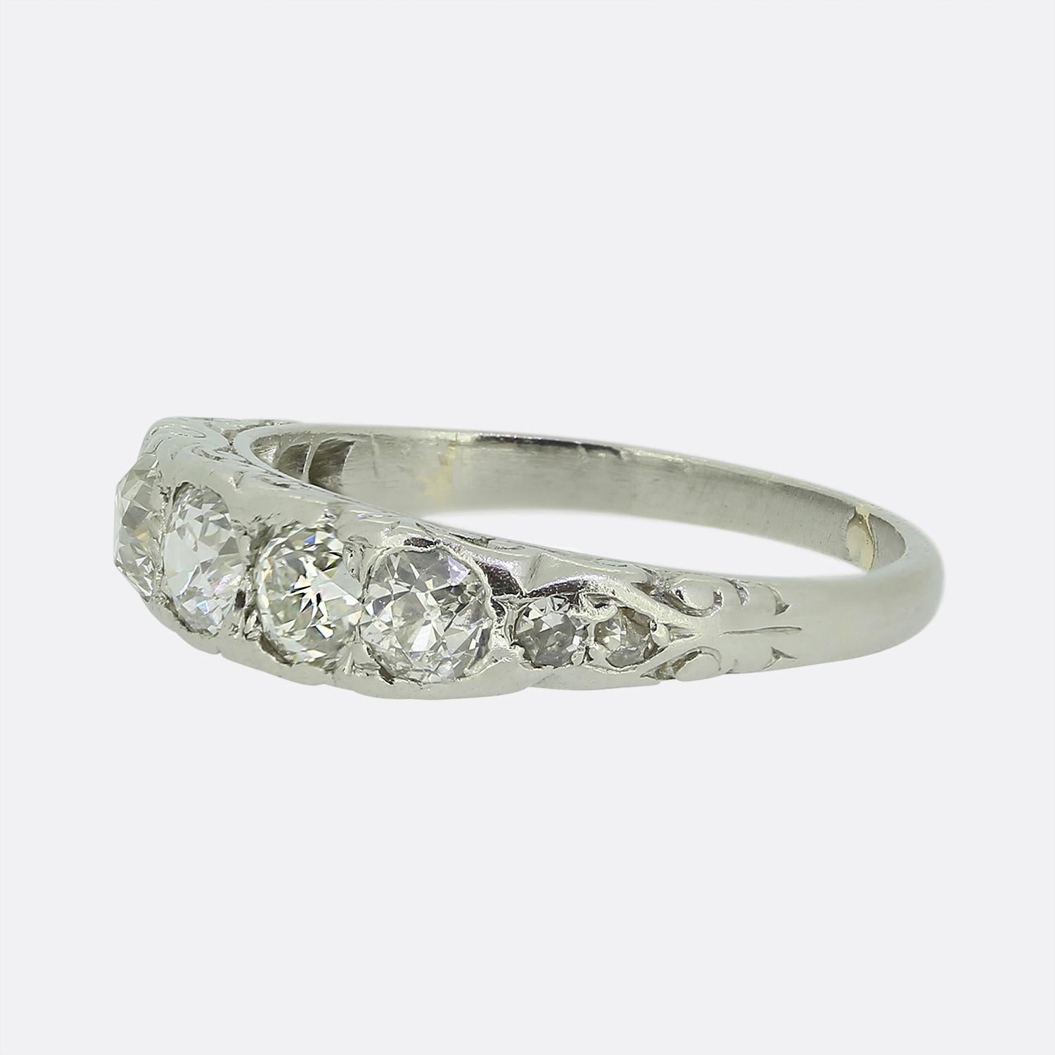 Here we have a splendid five-stone diamond ring taken from the late Victorian era. This antique piece has been crafted from platinum and features five round faceted old cut diamonds in a single line formation across the face. A duo of matching