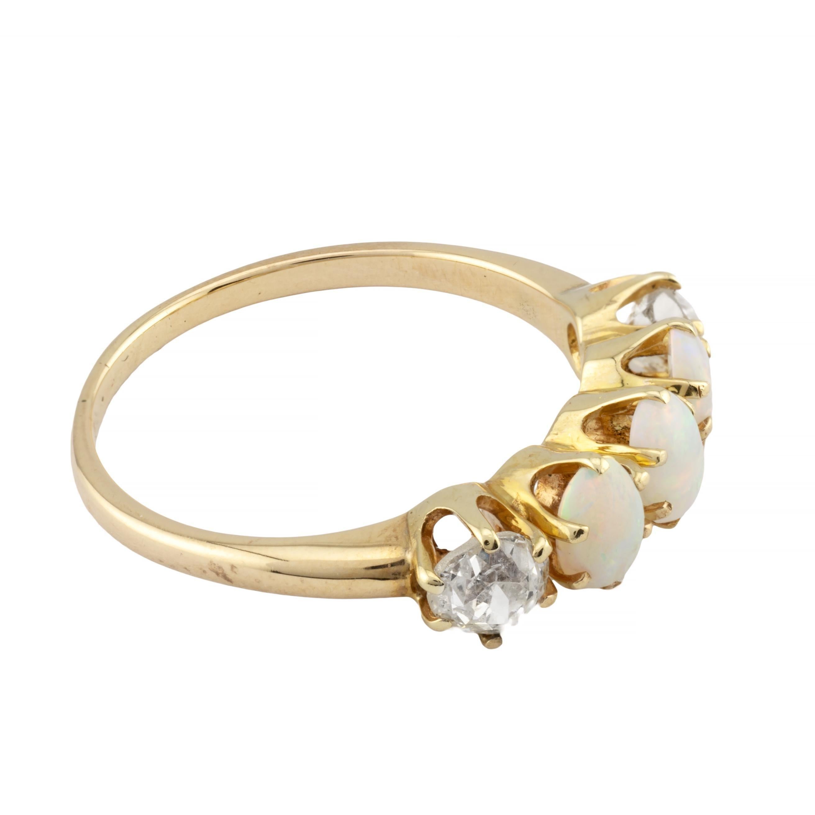 Aston Estate Jewelry Presents:

A victorian five stone opal and diamond band ring. Centered with a trio of cabochon cut opals framed with a pair of mine cut diamonds. Displaying beautiful flashes of green, blue, orange, and red the vibrant opals are