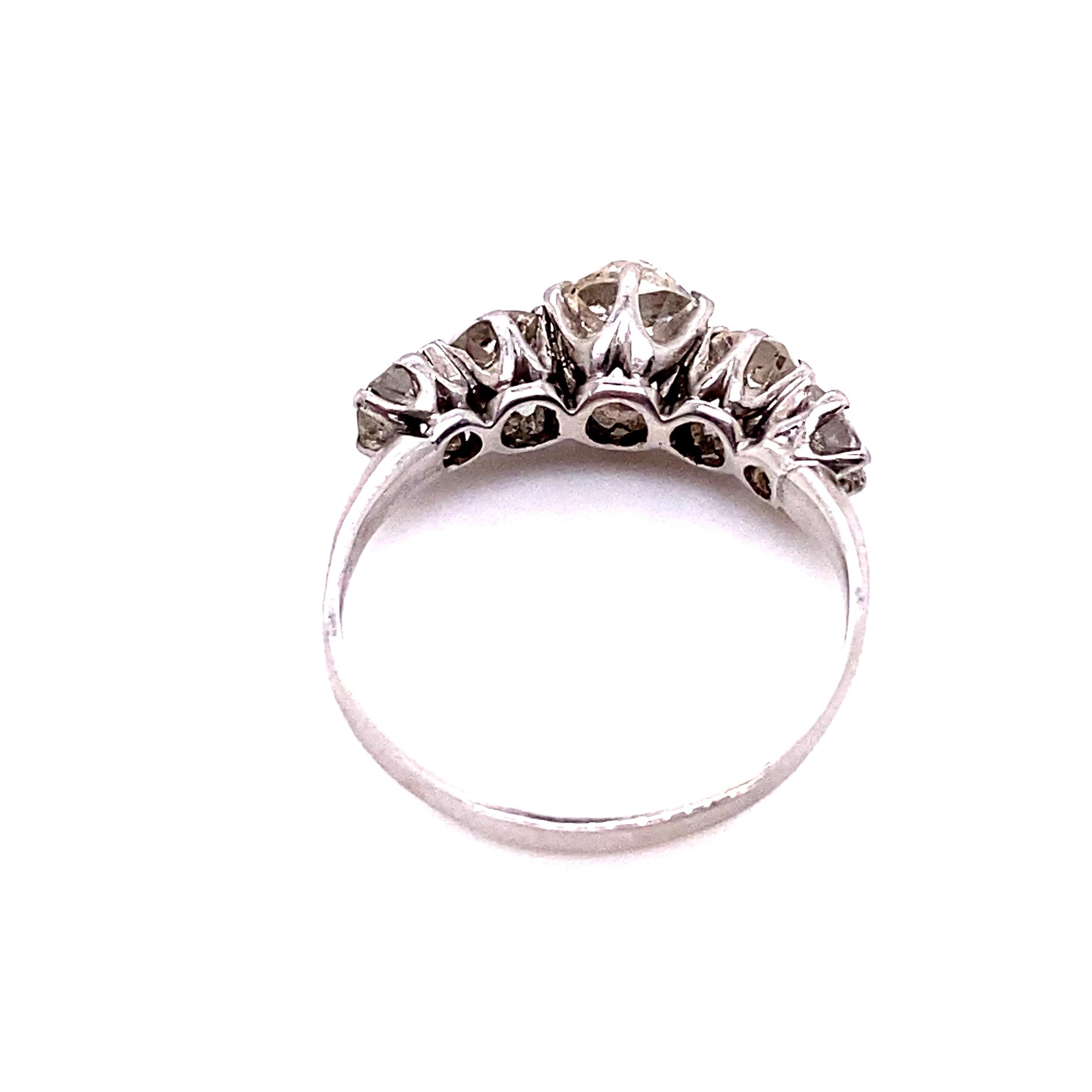 True romance: this beautiful five stone diamond ring dates to the early 1900s and is highly Victorian in style. The old mine cut diamonds graduate in size and are cradled by individual prongs. They match in quality, estimated as J to K in color and
