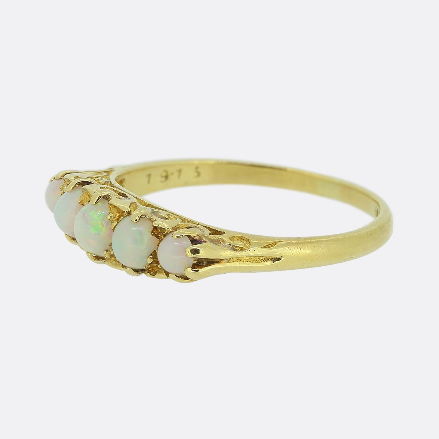 Here we have a beautiful, classically styled, five-stone ring dating back to the Victorian period. This antique piece has been crafted from 18ct yellow gold and features five round shaped opals which graduate inwardly in size in a single line