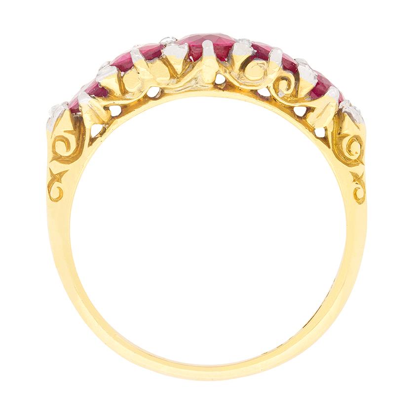This gorgeous five stone ring shows off a total weight of 1.40 carats of Rubies. They are a lovely red with a little pink hue to them. They are highlighted by rose cut diamonds which are rubover set parallel to them. The rose cuts have a total
