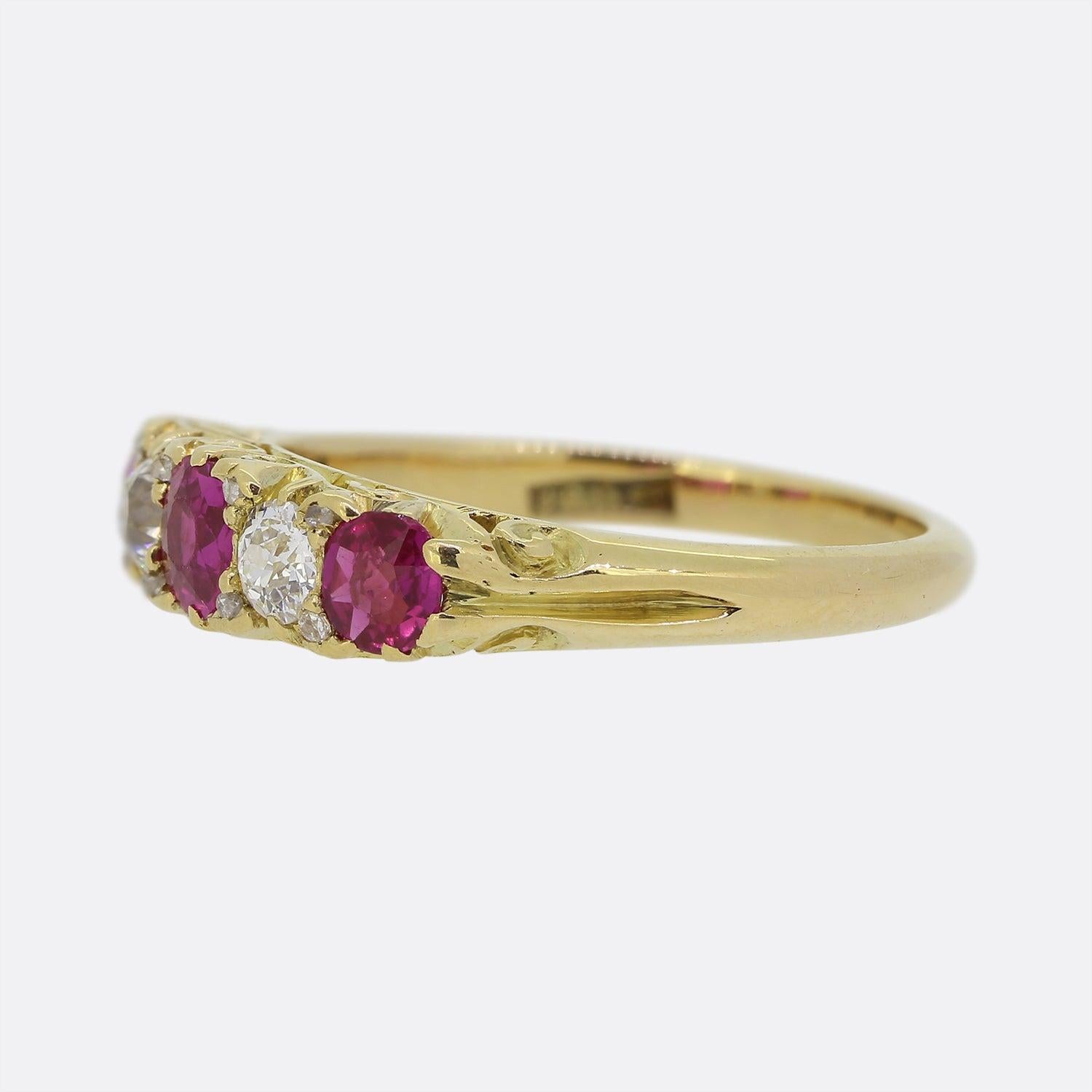 Here we have a 18ct yellow gold Victorian five stone ring. The piece showcases five round faceted gemstones in a single line formation including a trio of pink natural rubies and a duo of old cut diamonds in an alternating sequence. The piece is
