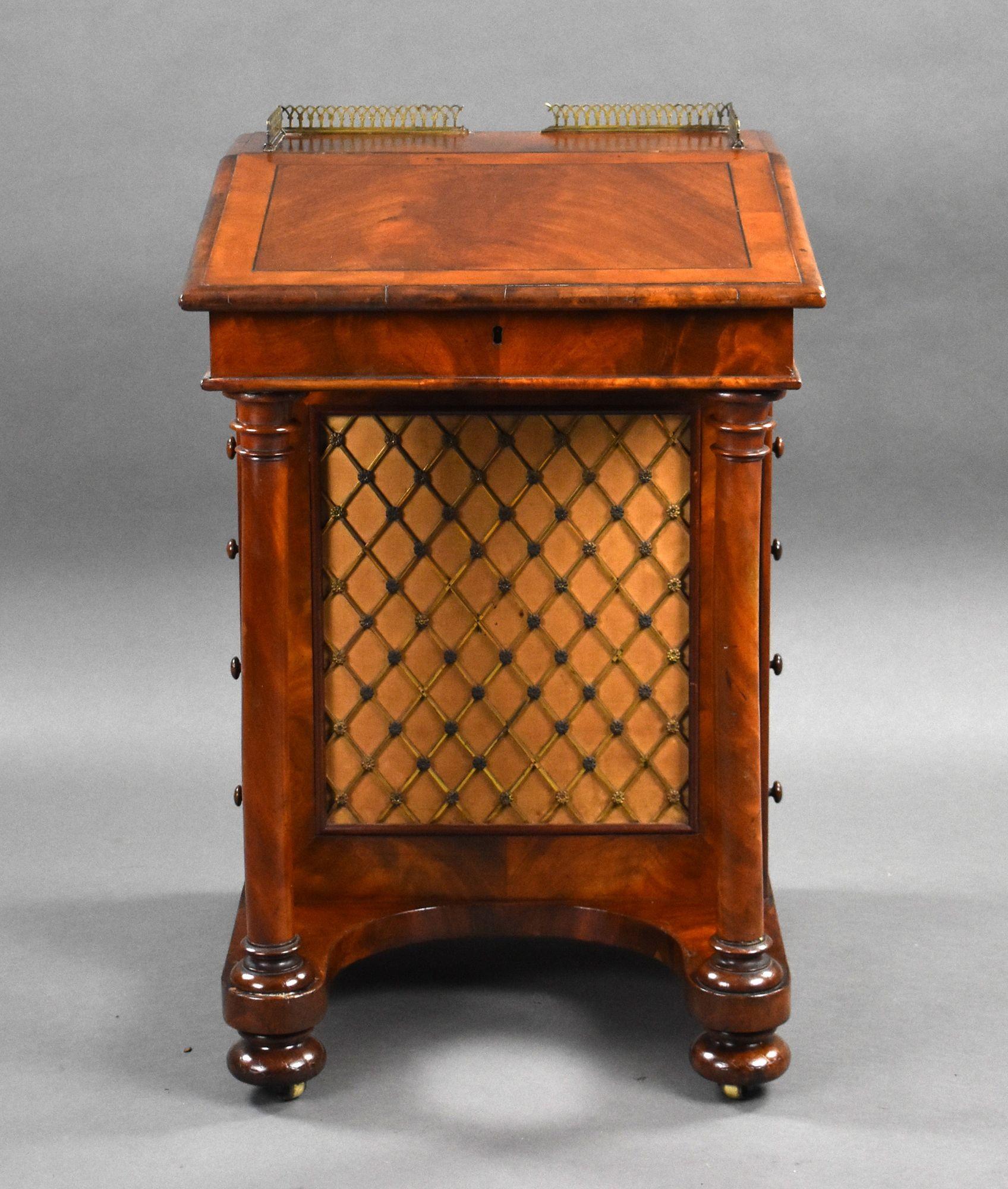 For sale is a good quality Victorian flame mahogany davenport, having a pierced brass gallery, above a rising fall, opening to two drawers, and two faux drawers, the left hand handle of the faux drawer pulls out to release the stationery drawer in