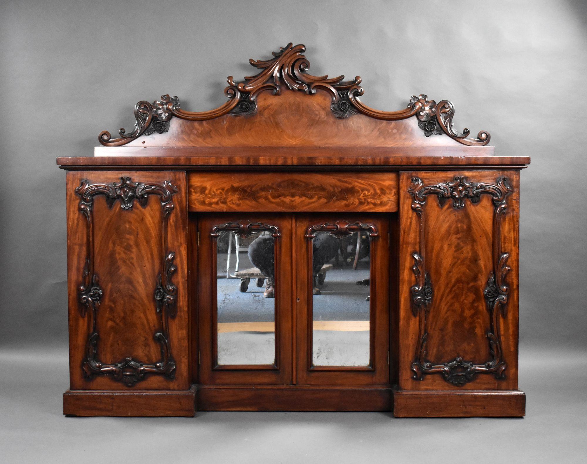 For sale is a good quality Victorian flame mahogany sideboard, having two mirror doors to the centre flanked by panel doors. The sideboard remains in very good ocndition for its age.

Width: 169cm Depth: 61cm Height: 144cm