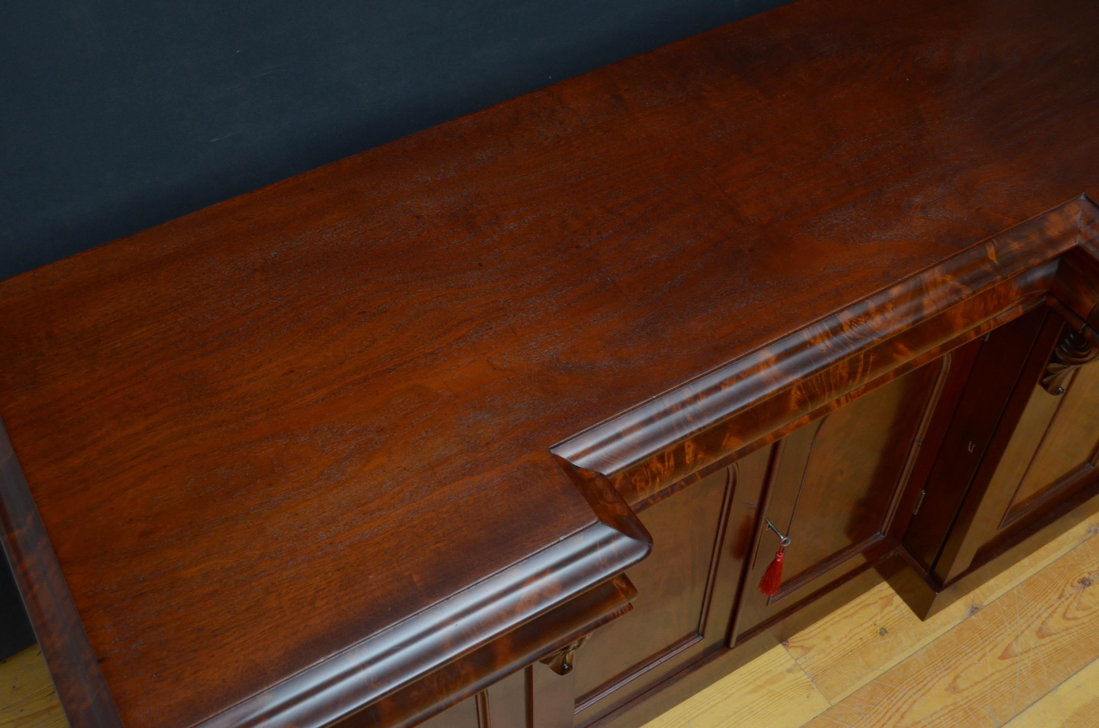 Sn4849, superb Victorian mahogany, break fronted sideboard, having figured mahogany top with moulded edge above 3 mahogany lined flamed mahogany drawers and a pair of flamed mahogany arched cabinet door fitted with working lock and a key and