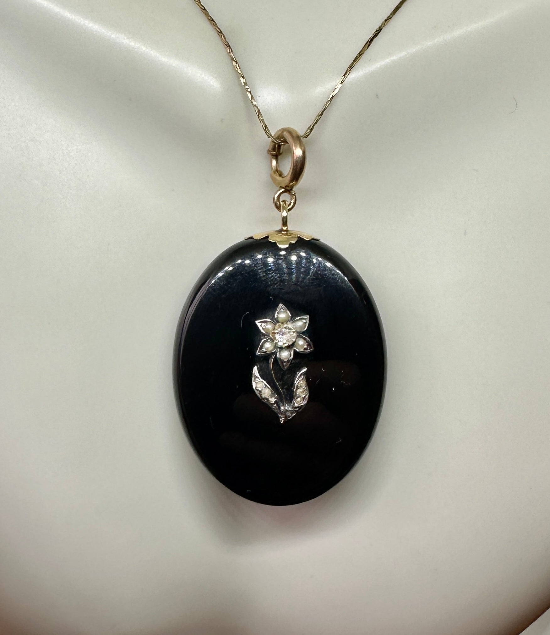 This is a magnificent Antique Victorian to Art Deco Old Mine Cut Diamond and Pearl Locket Pendant in Black Onyx and Gold with an exquisite diamond and pearl  Flower on the Black Onyx.   The picture locket is one of the finest antique lockets we have
