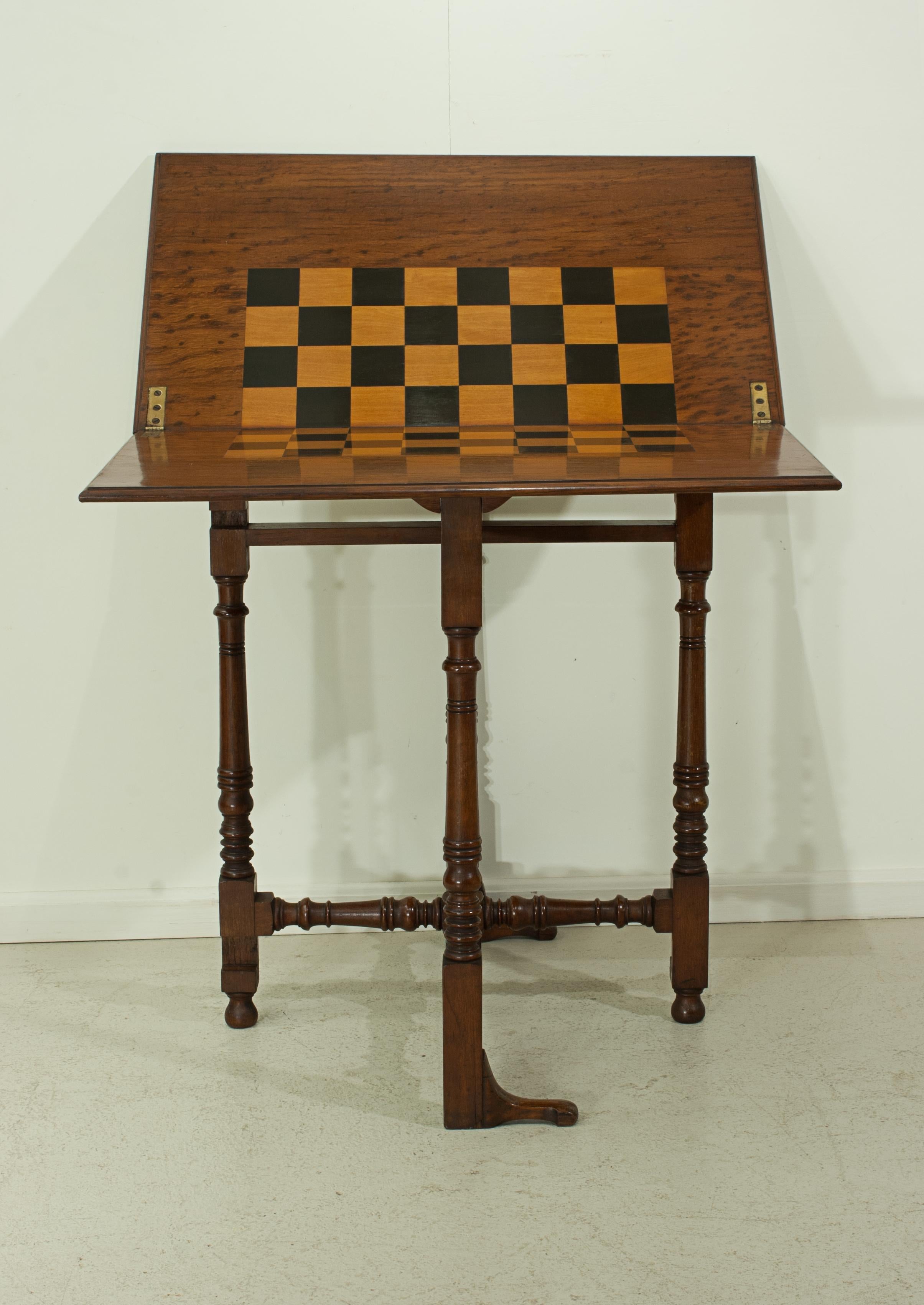 Charles Baker's folding chess table.
An exceptional folding chess or draughts table made of oak. The table with brass plate reading 