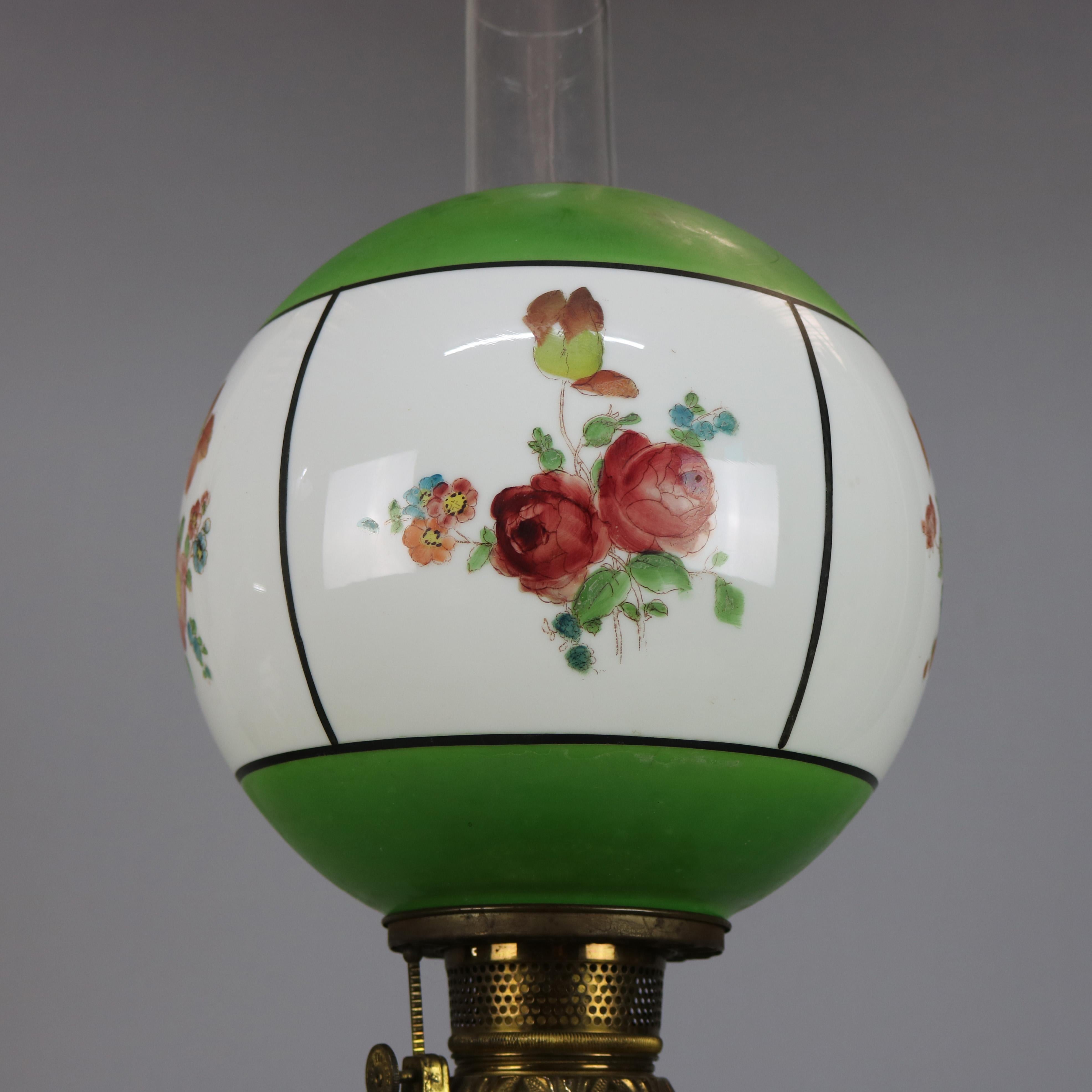 An antique Victorian gone-with-the-wind electrified kerosene banquet parlor lamp by Fostoria offers glass shade and base with hand painted floral reserves, raised on pierced gilt metal foot, electrified, FGCO mark on base, circa 1890

Measures: